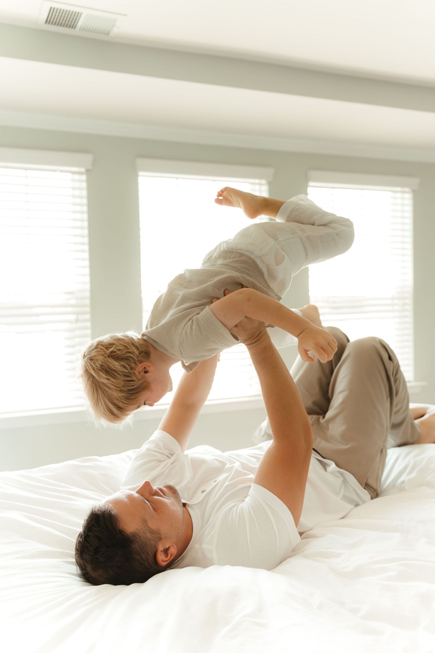 Father tickling son during an in-home family lifestyle session in Fort Mill, SC.