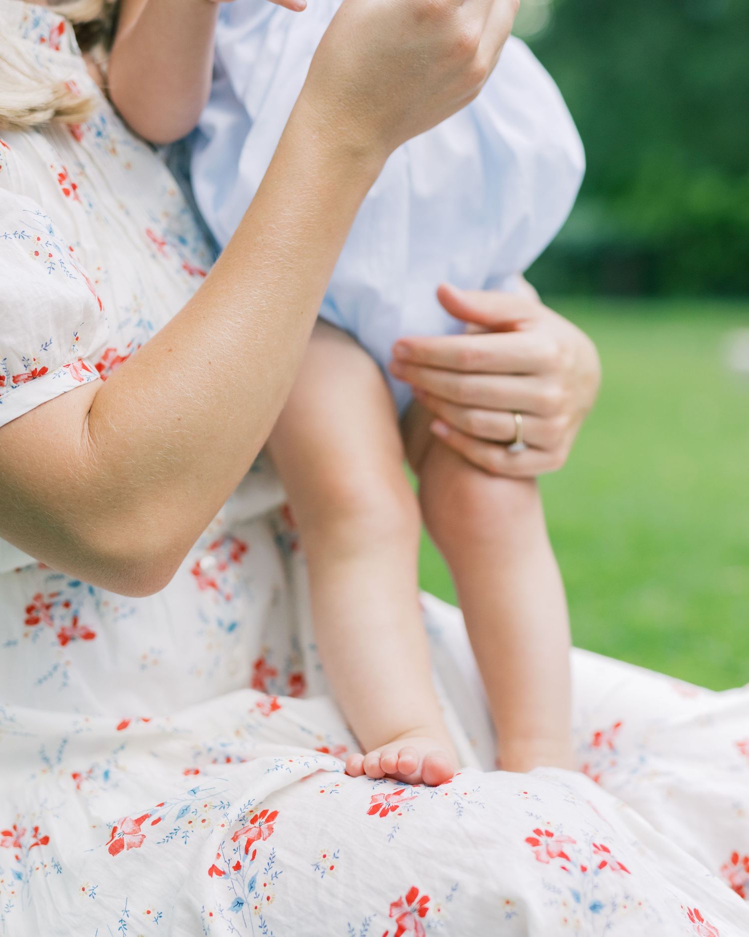 Motherhood Photography capturing details holding her small child and featuring cute little toes