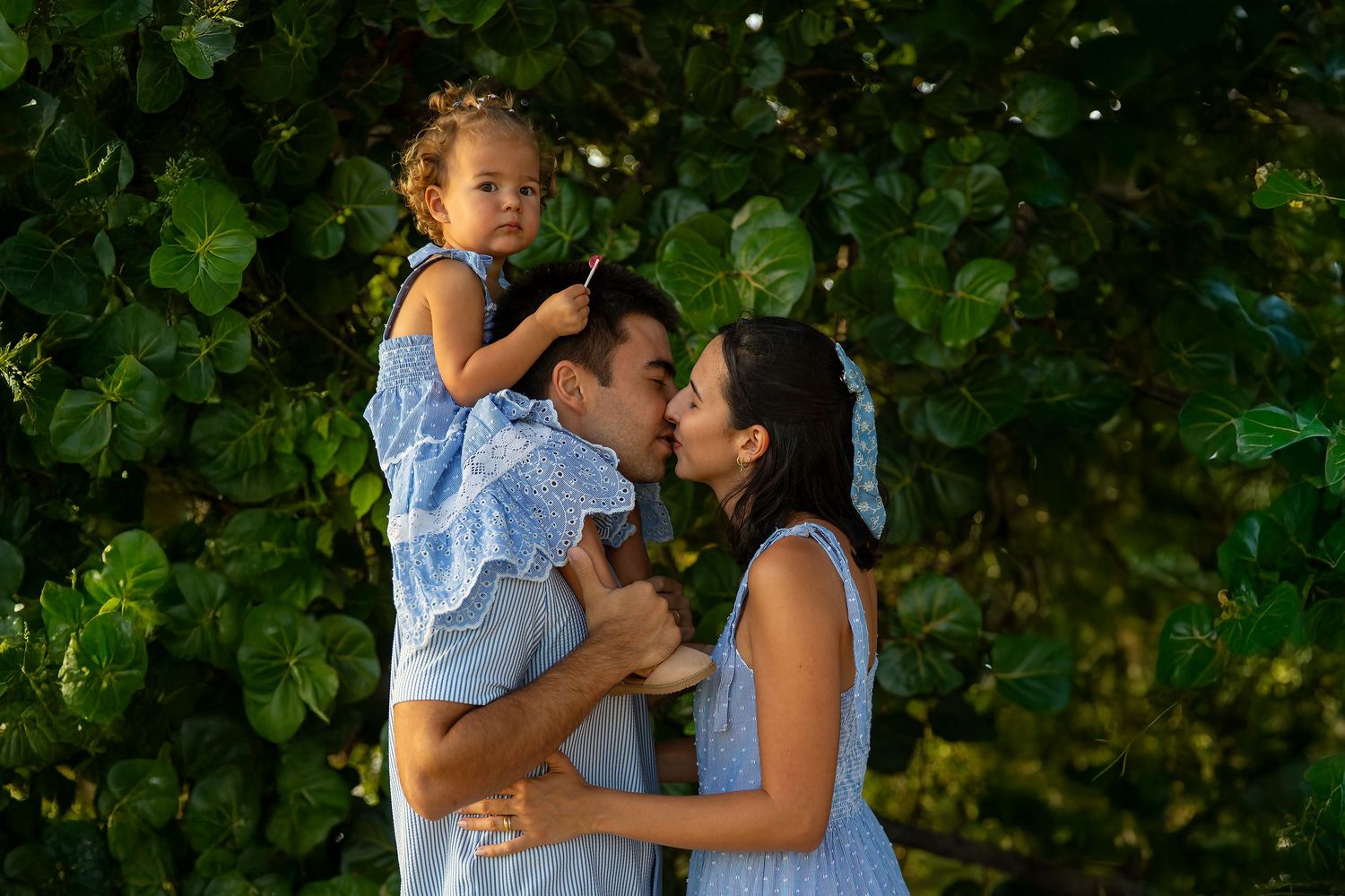 Dad holding her daughter during a natural outdoor family photography session in South Florida