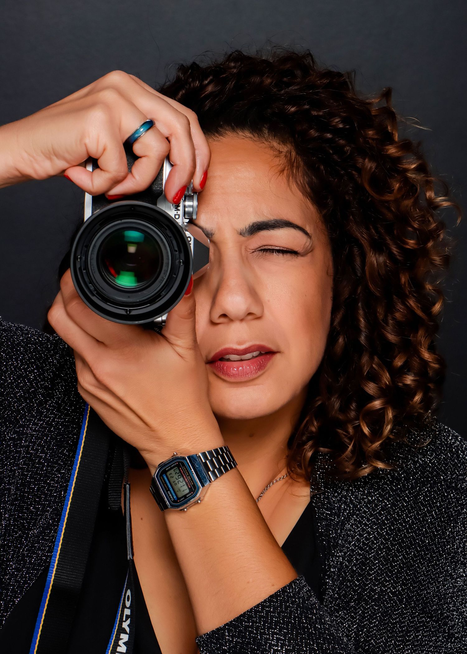 Female photographer capturing a portrait with a professional camera