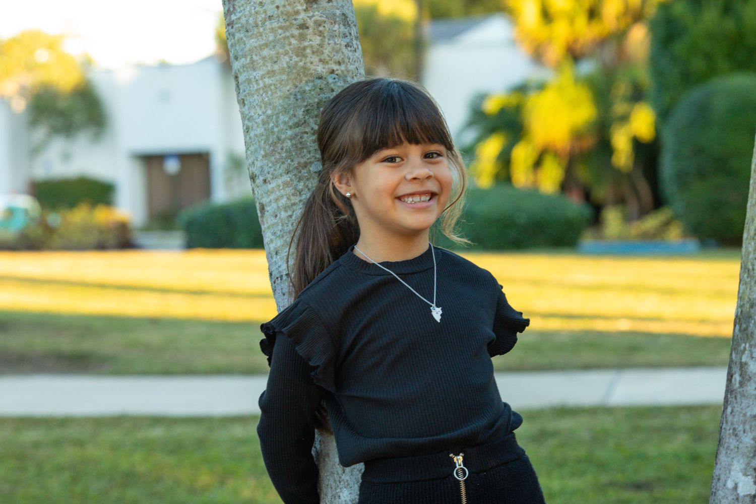 Young girl smiling outdoors during a natural kids portrait photography session