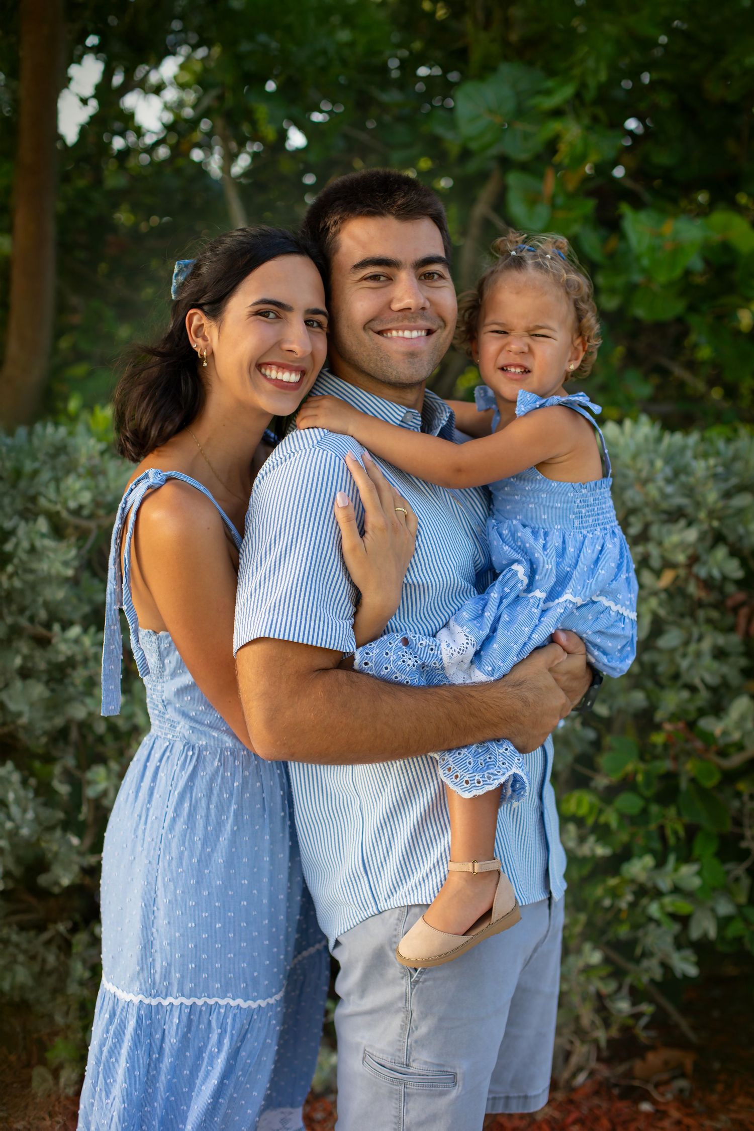 Dad holding her daughter during a natural outdoor family photography session in South Florida