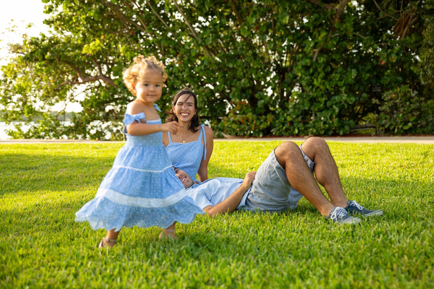 Mother and daughter smiling together during a sunset outdoor photography session