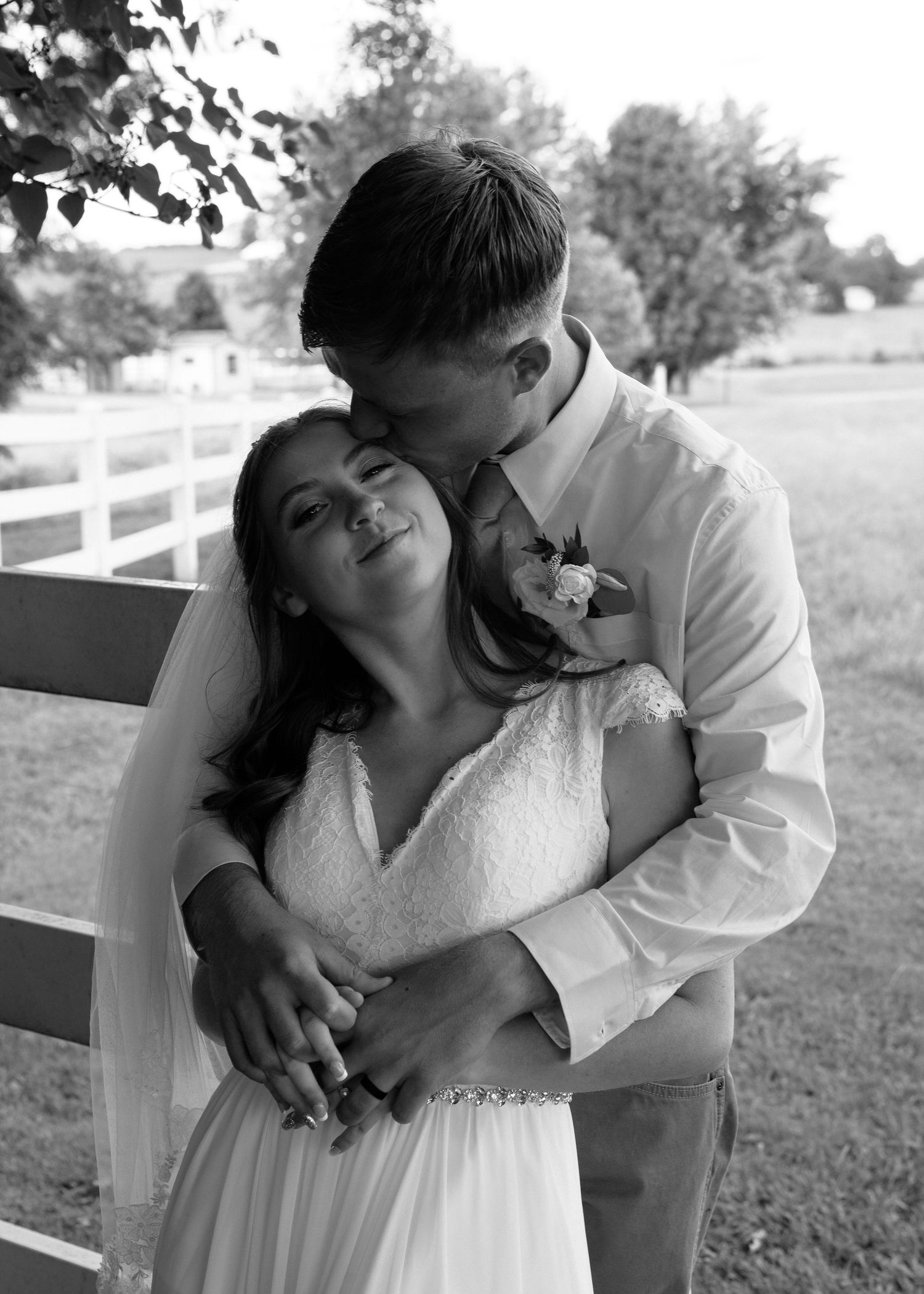Black and white series of intimate wedding moments captured against white fence backdrop.