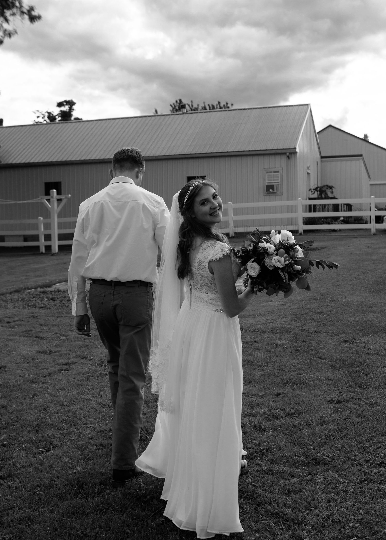 Black and white photo series of newlyweds walking together across an open field.