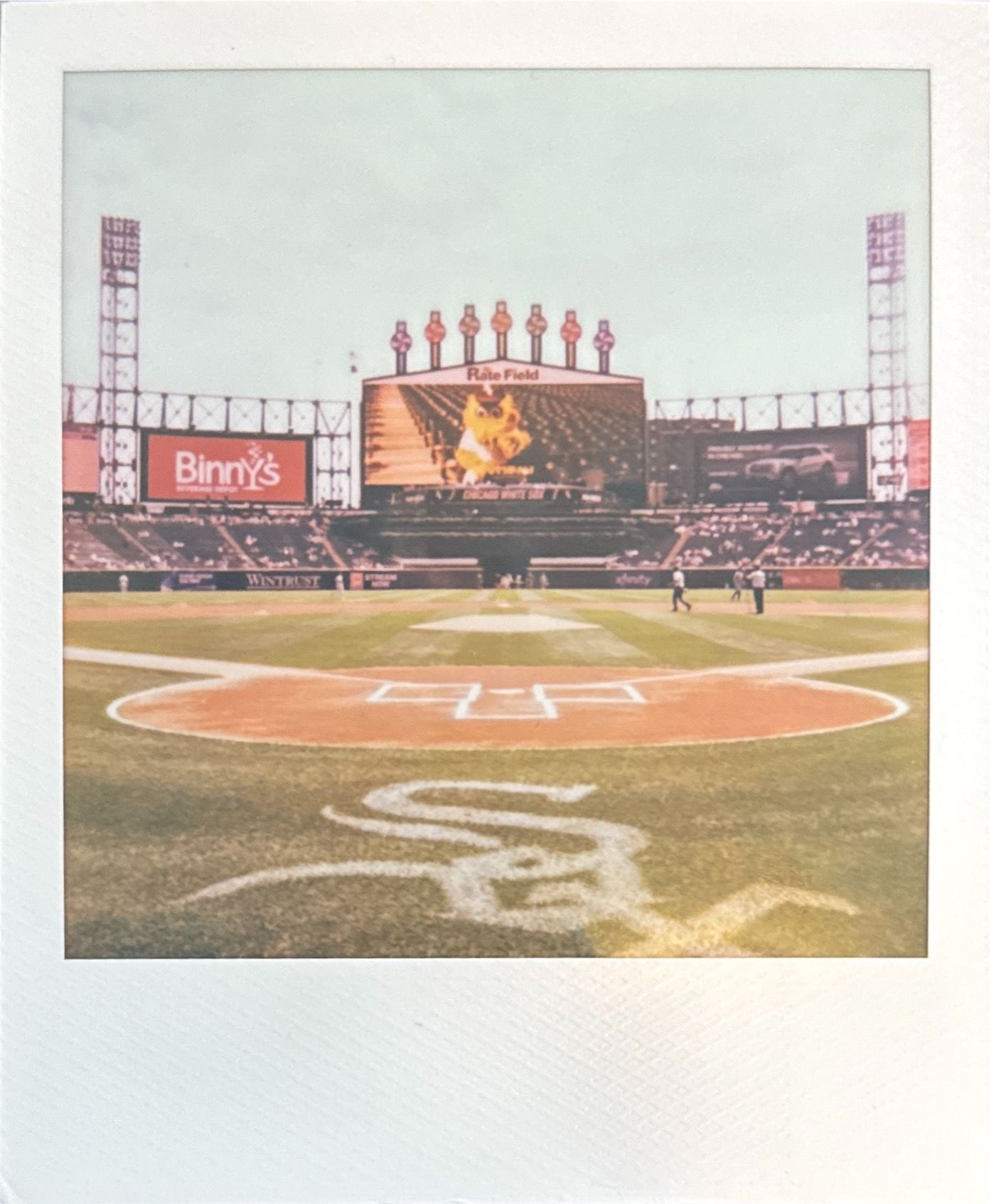 View of baseball diamond and outfield at White Sox stadium with scoreboard visible.