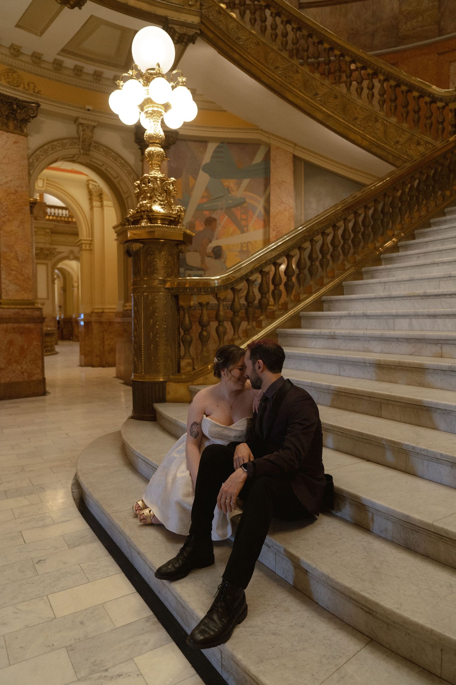 a couple sitting on the stairs forehead to forehead
