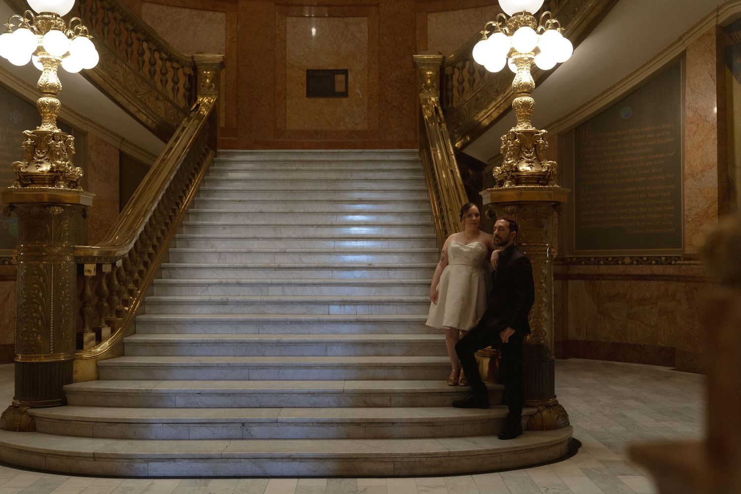 a couple standing on the stairs of the denver capitol building for an old money style photoshoot