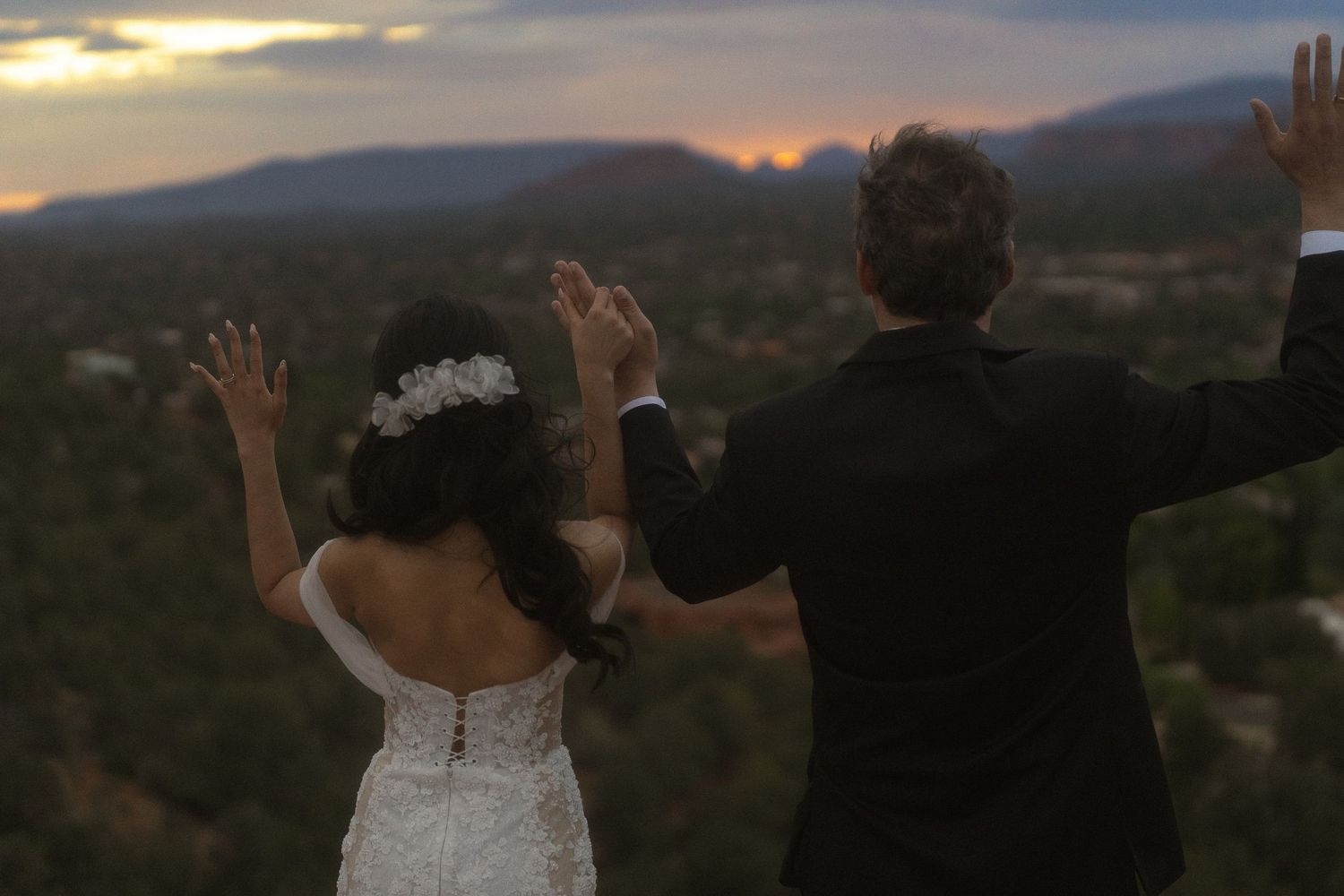a bride and groom on top of the sedona Vortex after getting married