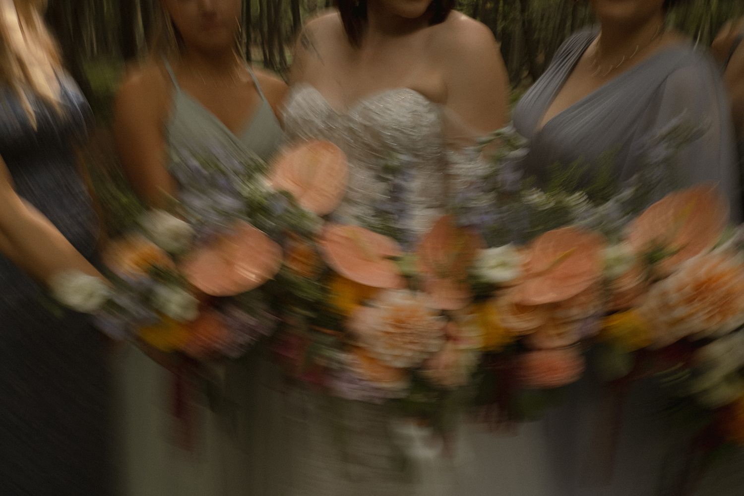 a bride and her bridesmaids hold their bouquets for detailed shots including their hands arms and florals, a swirled technique is used