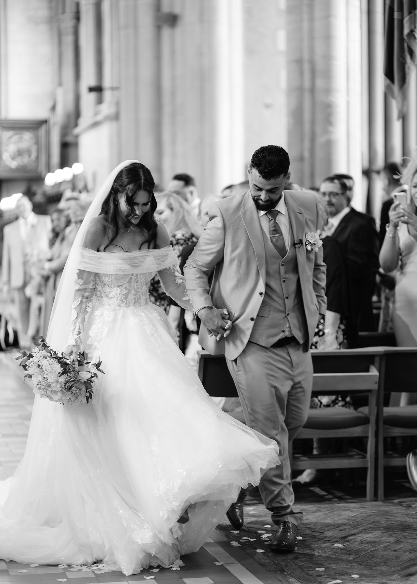 A wedding couple dances and twirls in a sequence of black and white photos showing movement in an elegant venue.