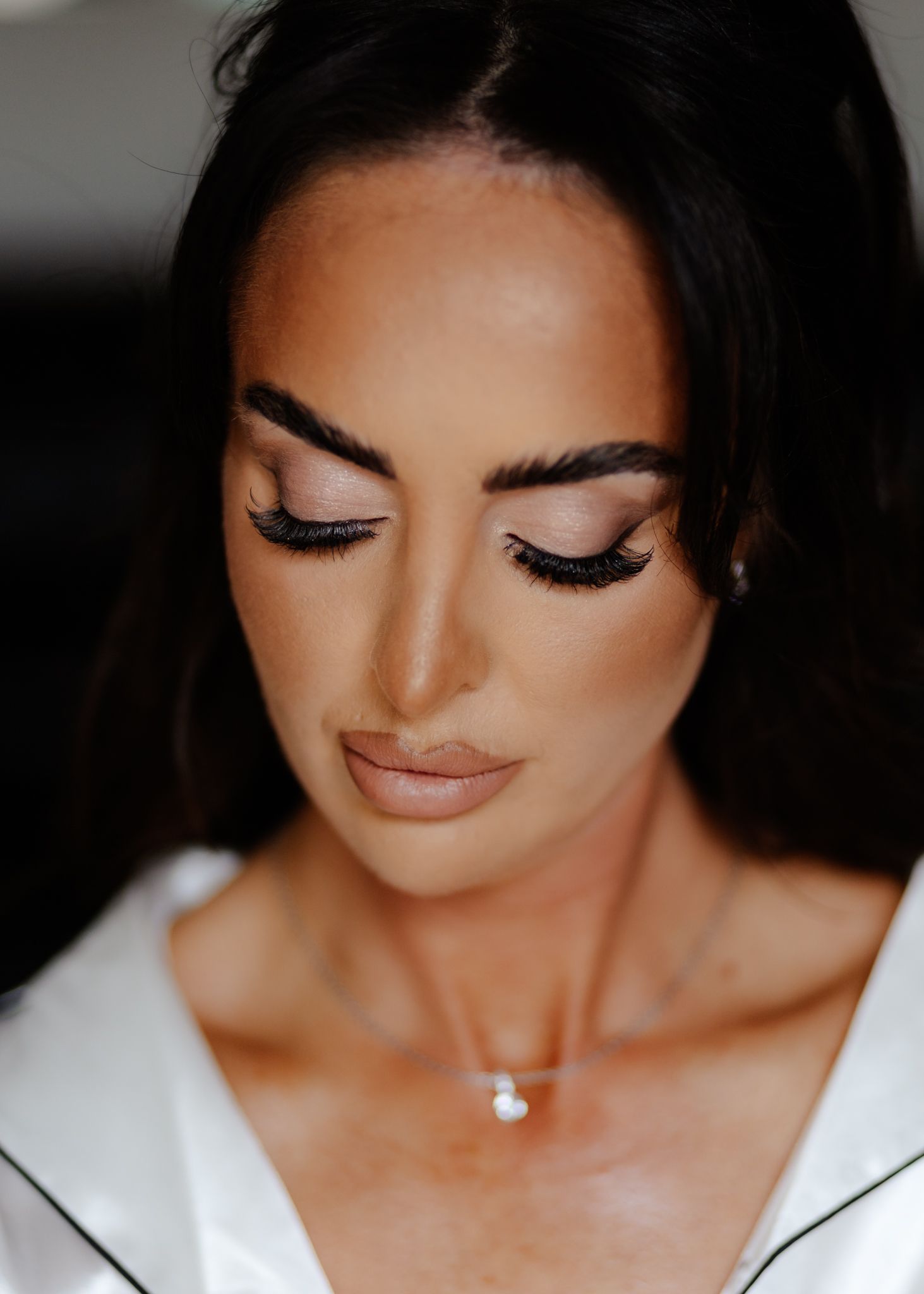 Close-up beauty portrait showing glamorous eye makeup with long lashes and defined brows.