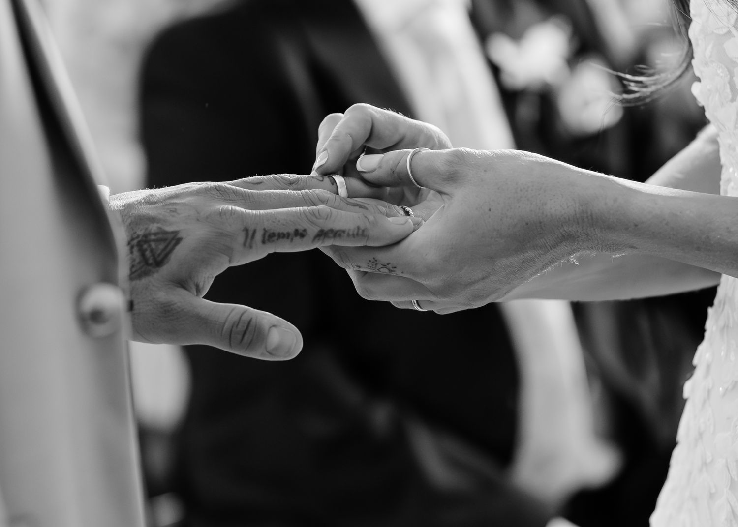 Hands passing paper documents back and forth in a formal business setting.