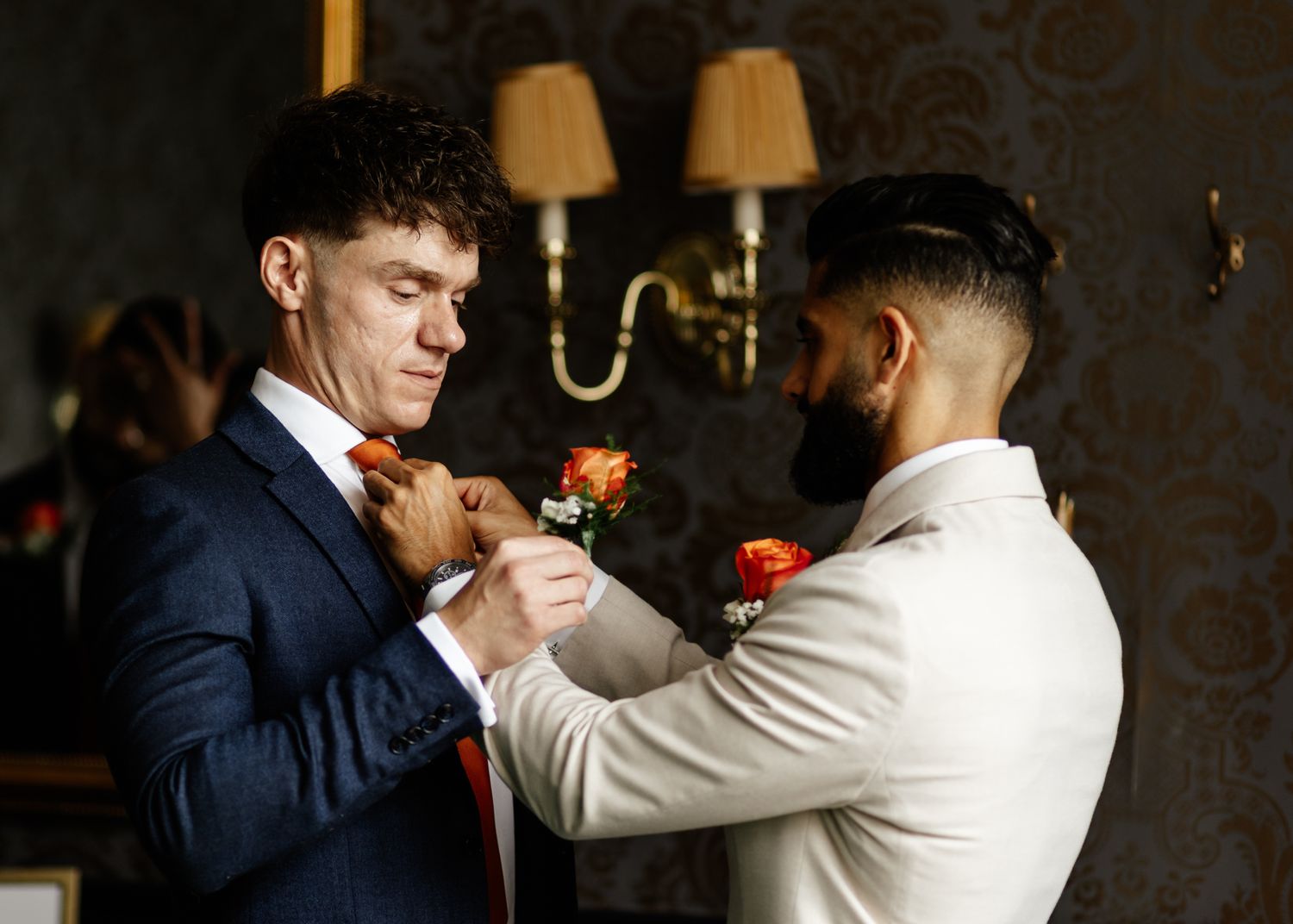 Two dancers perform an elegant ballroom dance sequence in a dimly lit room with warm lighting.