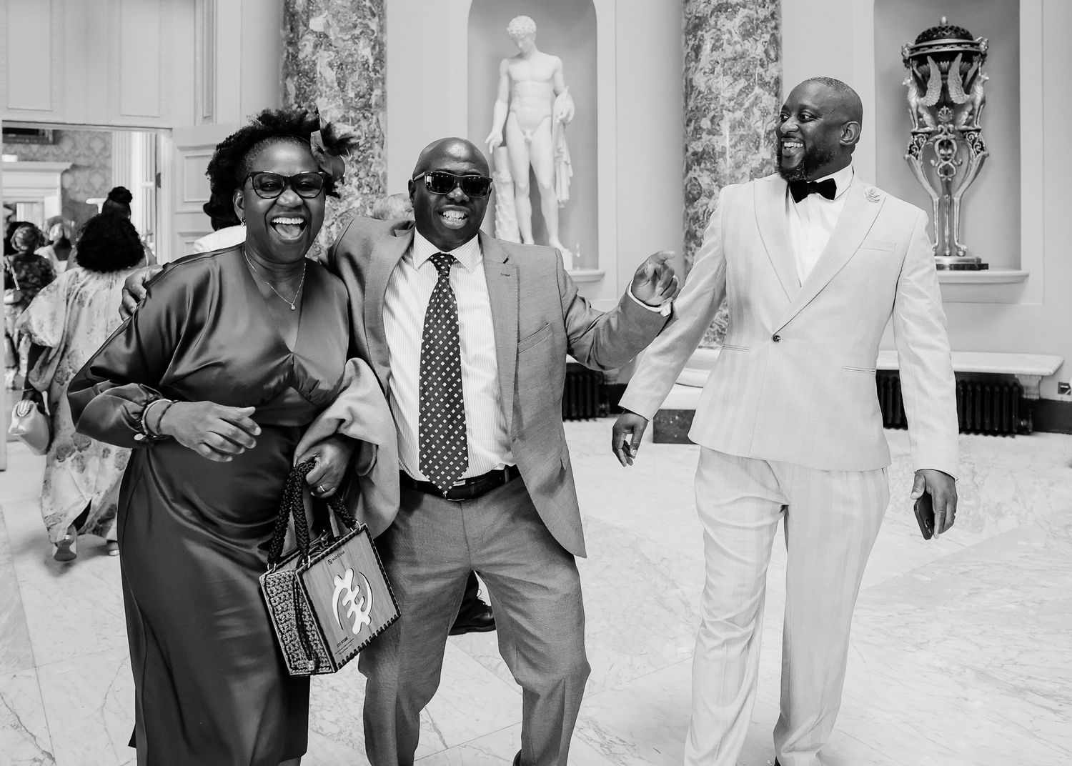 Wedding guests dancing and celebrating in black and white photography series.