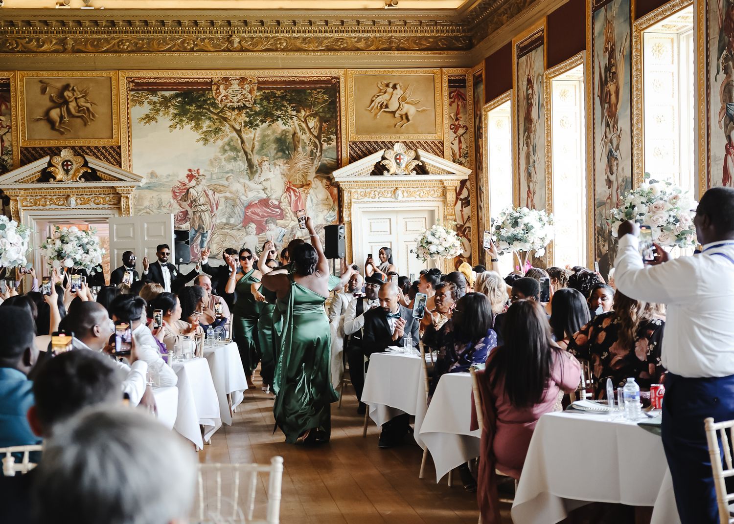 Ornate reception hall with frescoed ceiling and elegant table settings for wedding celebration.