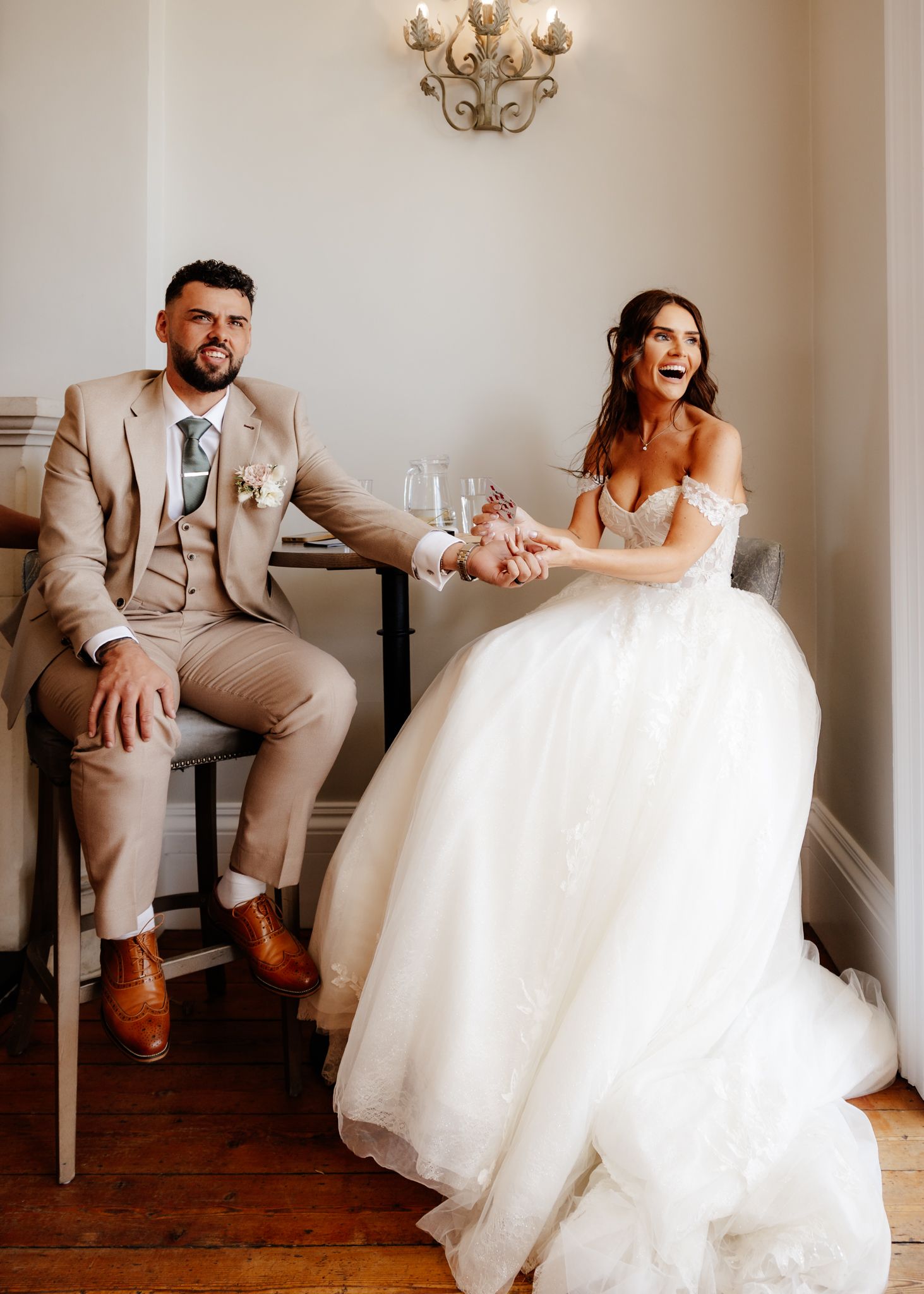 A series of candid wedding photos showing a couple sharing playful moments on a white couch.