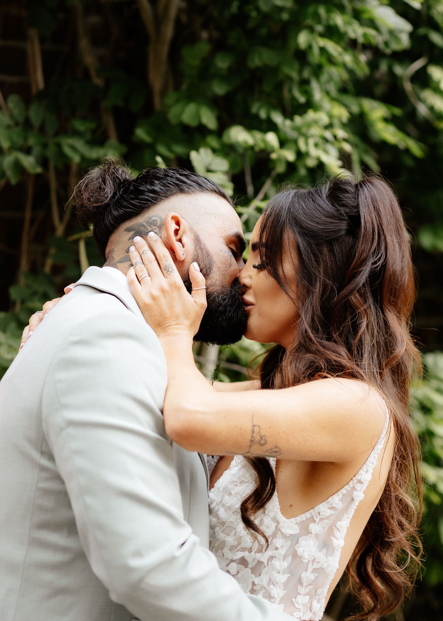 A romantic sequence of wedding photos shows a couple sharing a passionate kiss against a lush garden backdrop.