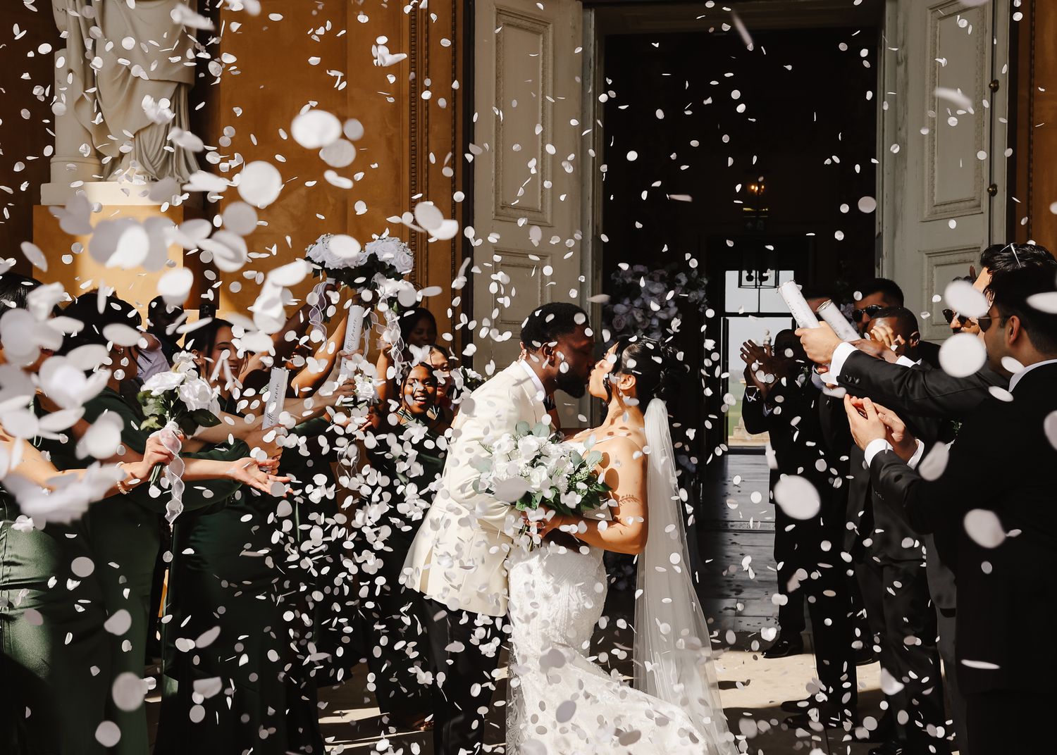 Wedding celebration with white confetti falling and floating through the air during an indoor reception party.