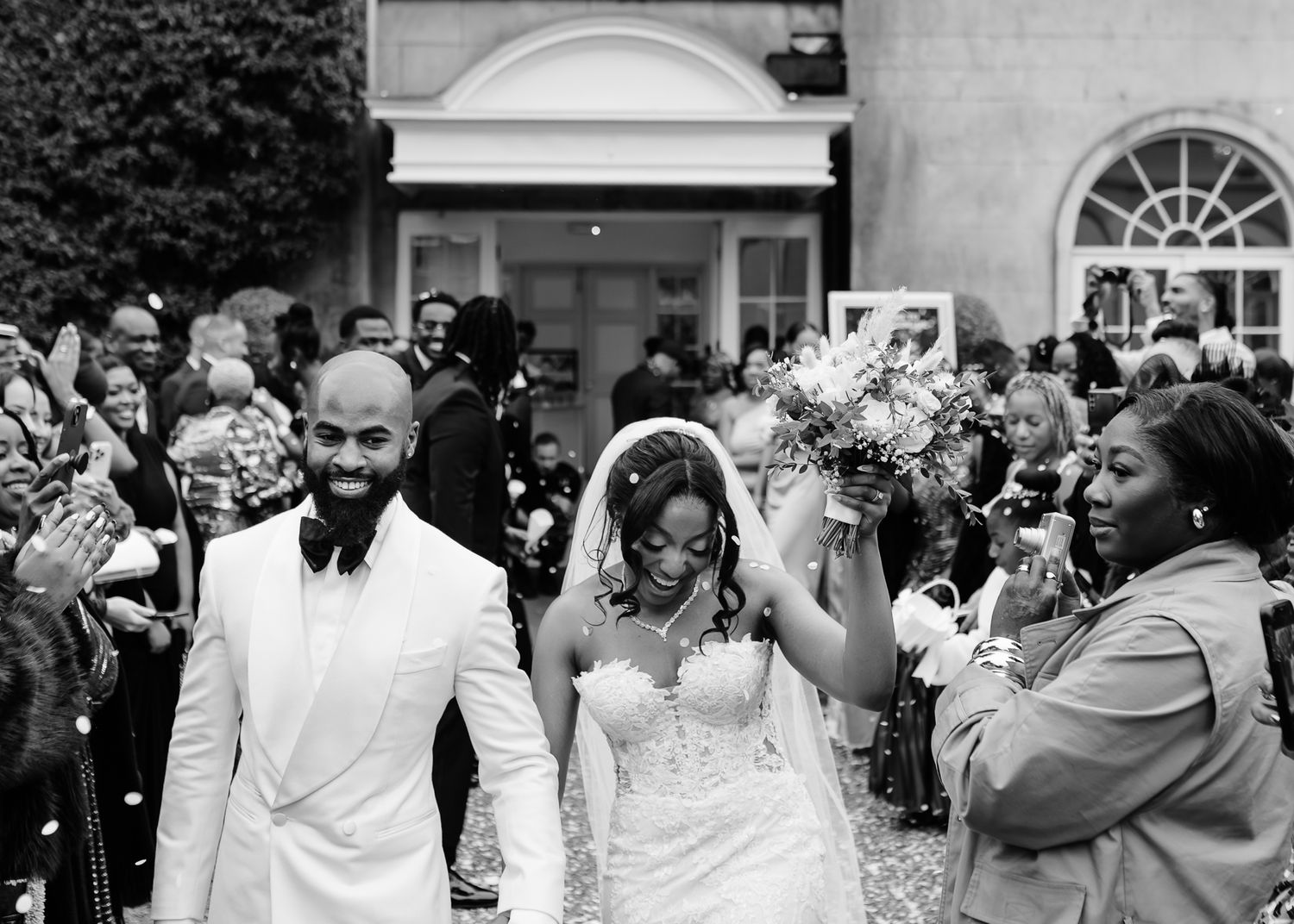 Black and white collage of candid wedding moments showing celebrations and emotional reactions during a reception.