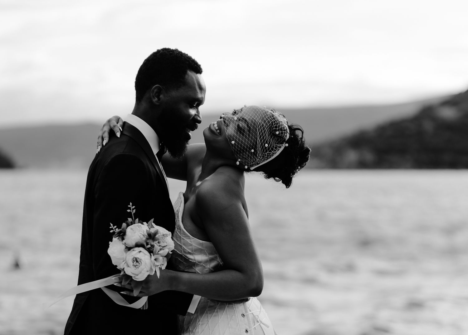 A romantic black and white photo series of a couple on their wedding day sharing intimate moments together.