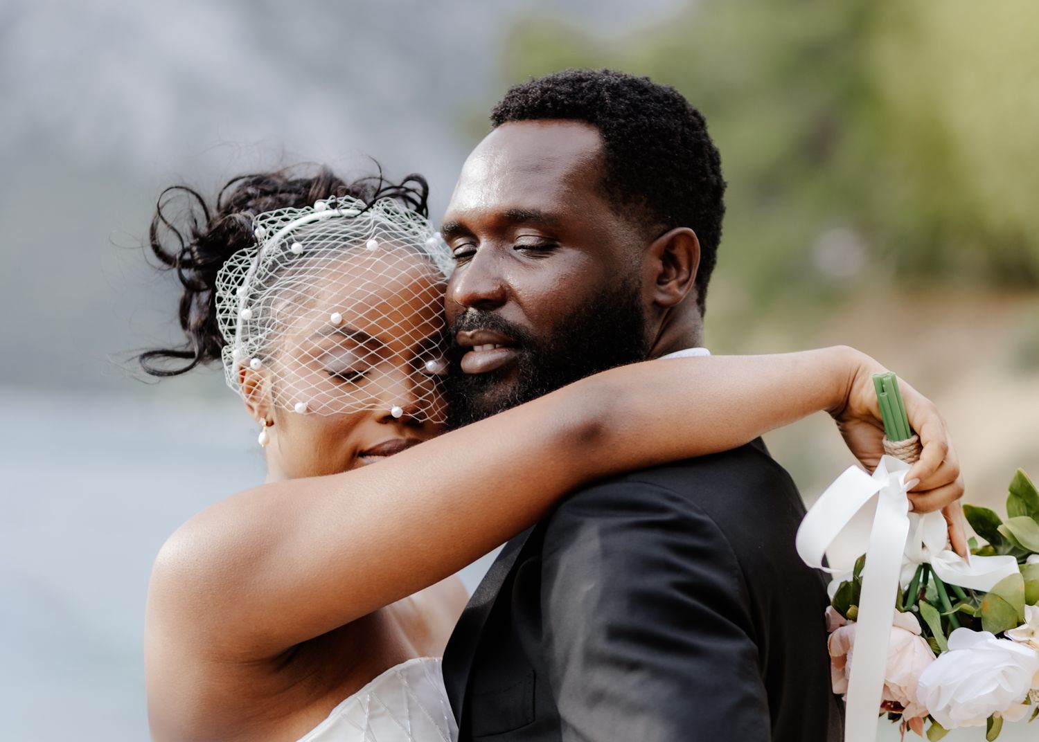 A romantic wedding couple shares tender moments in a series of black and white photographs.