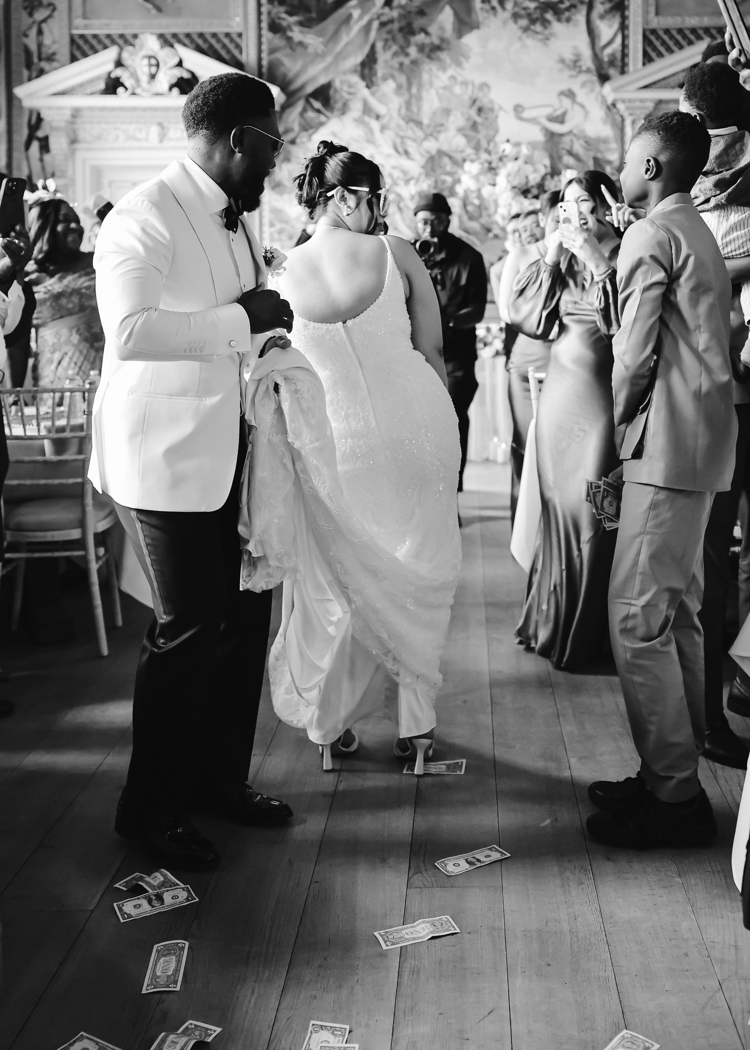 Wedding reception dance floor with guests dancing in formal attire.
