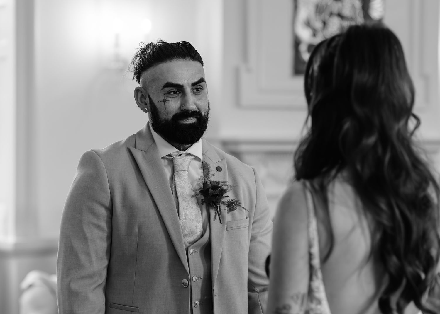 A black and white photo collage showing candid moments from a wedding celebration.