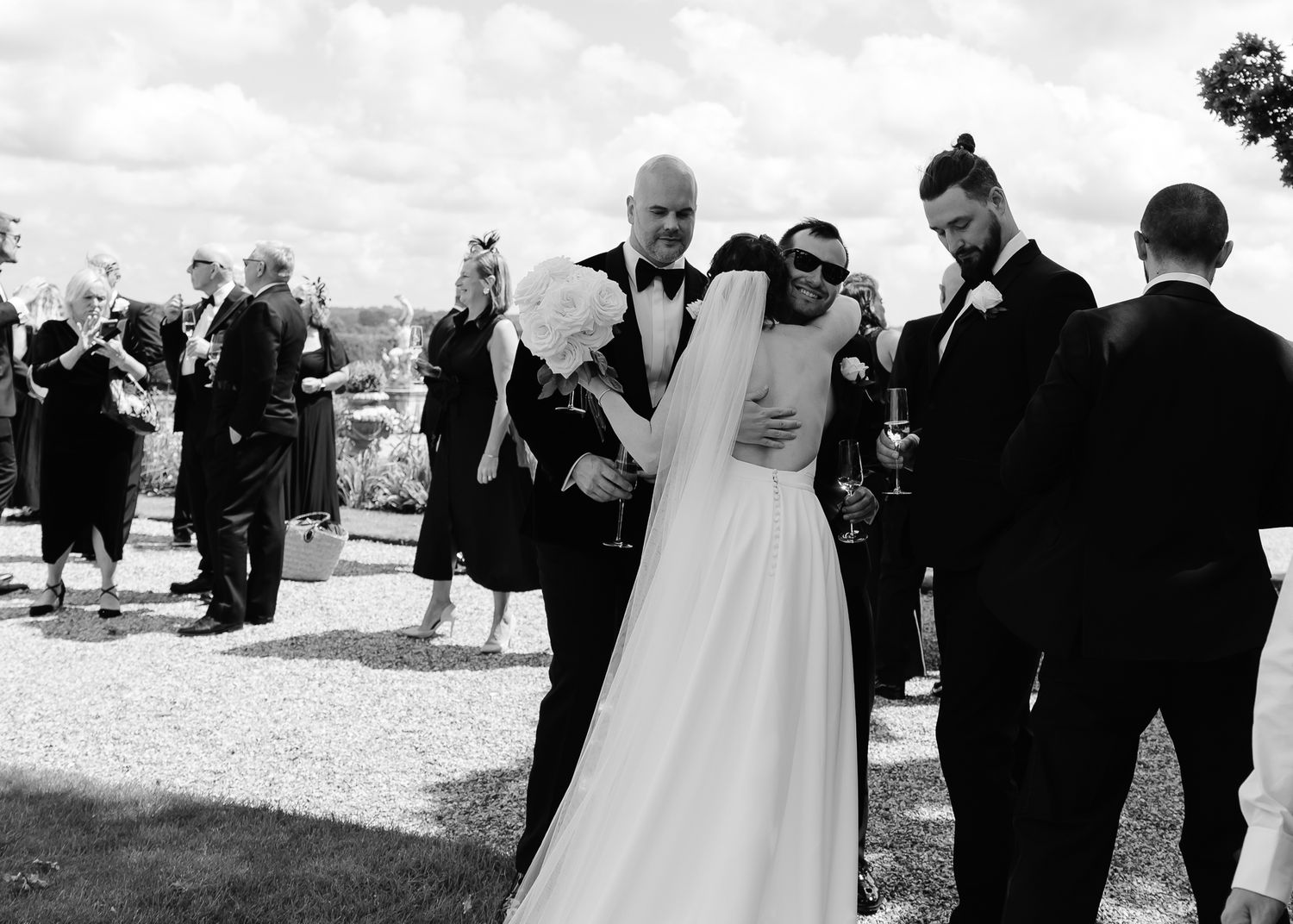 Wedding guests mingle and socialize outdoors at an elegant reception celebration.