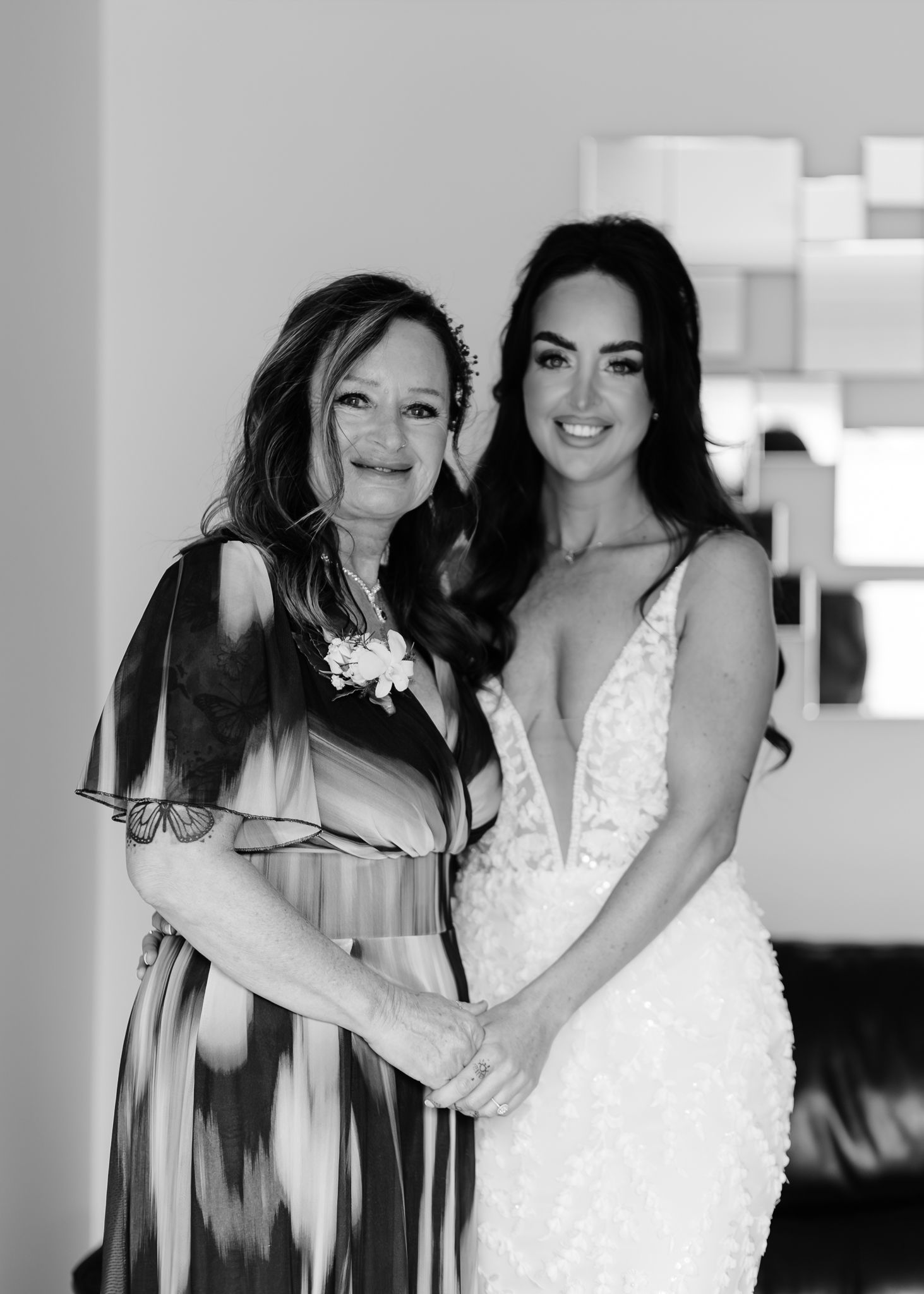 A sequence of black and white wedding photos showing tender moments between a bride in a white dress and loved ones.