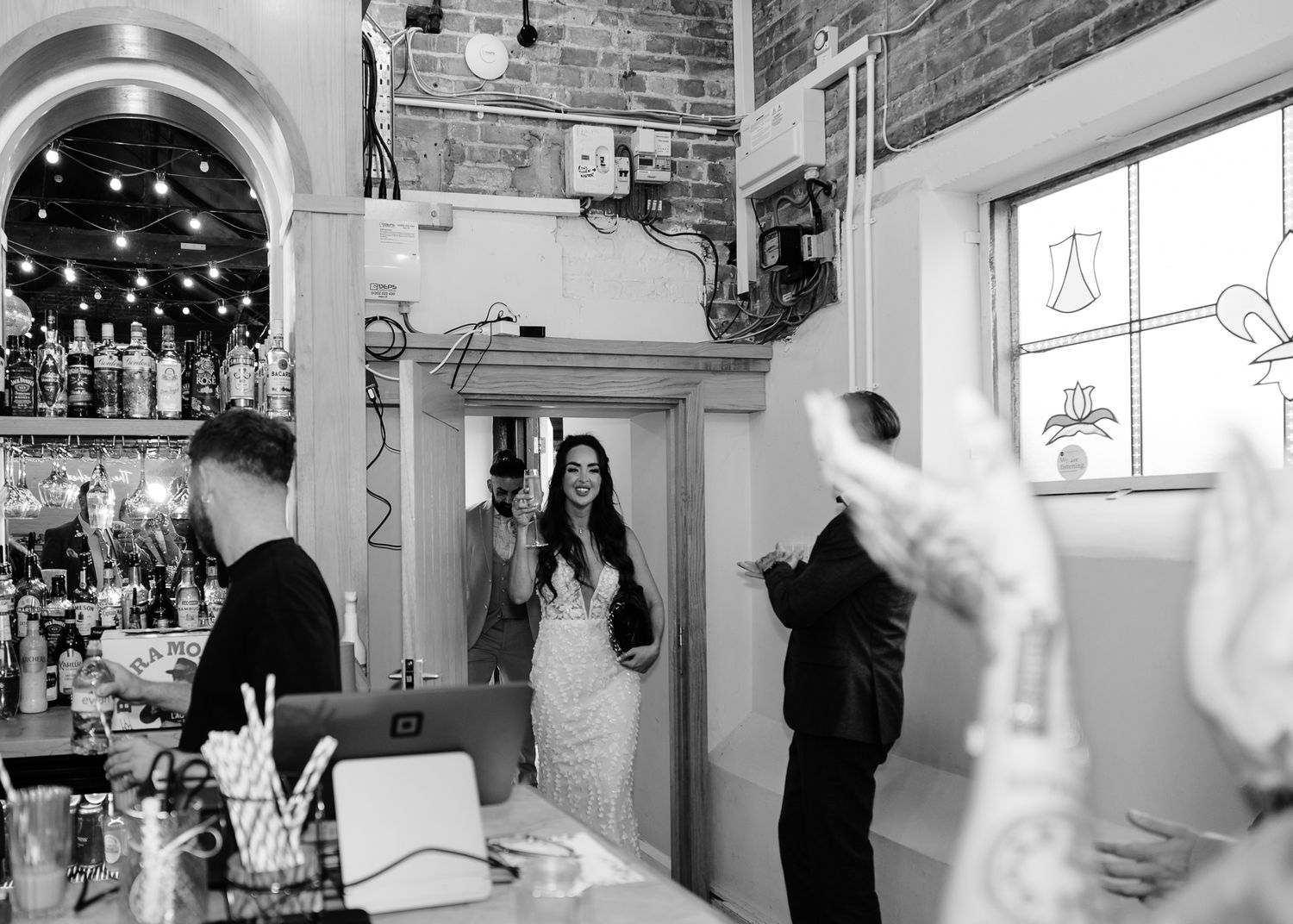 A series of black and white photographs showing people dancing and socializing at what appears to be a bar or party venue.