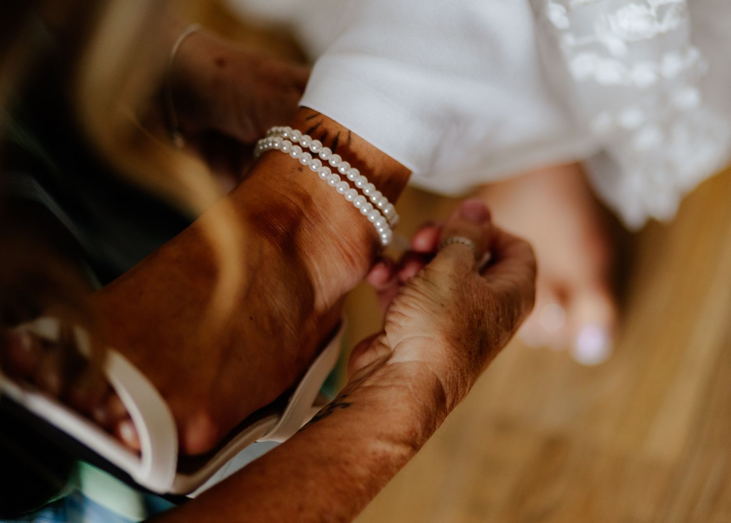 Close-up view of hands holding a mobile phone during a wedding ceremony.