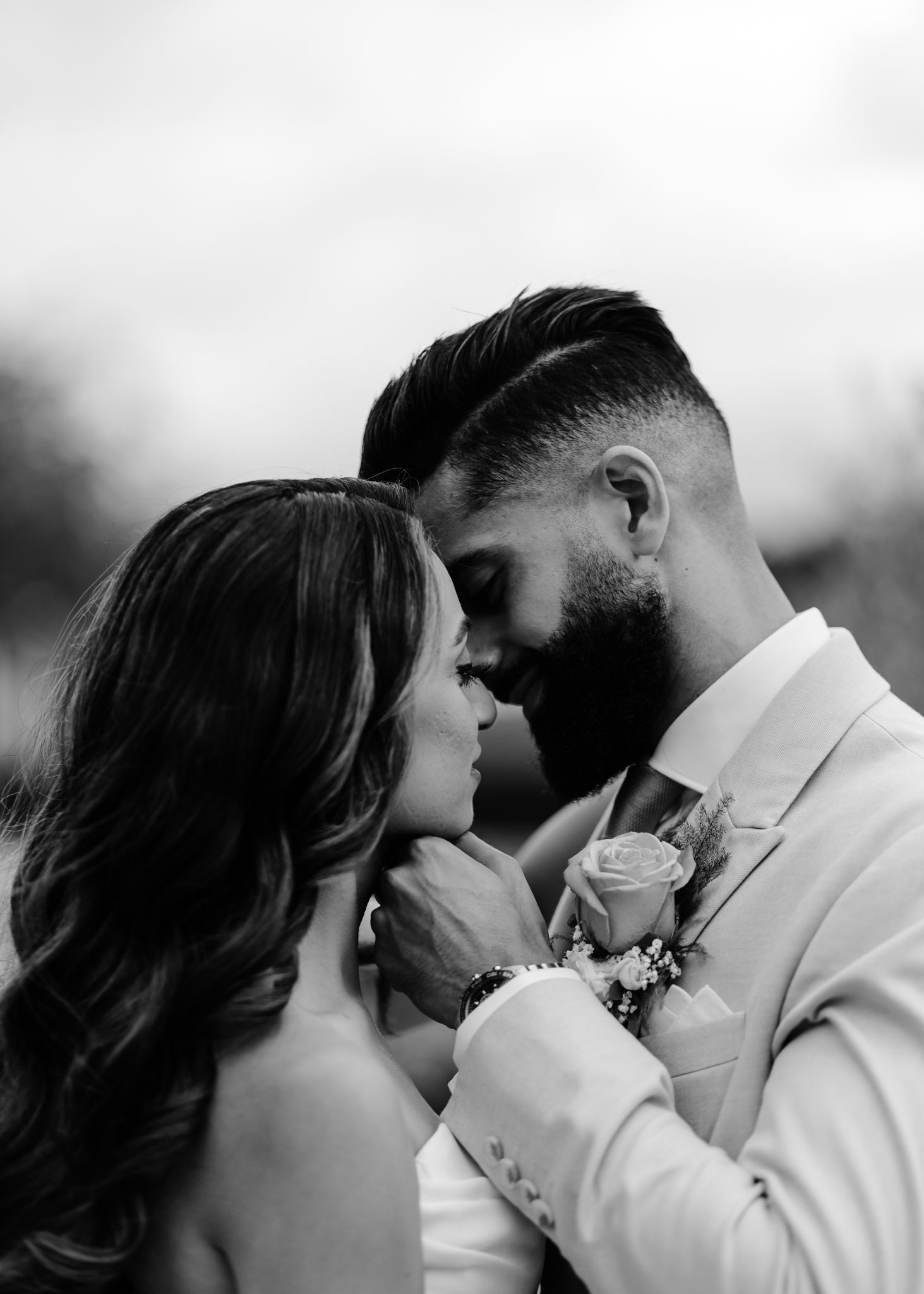 A romantic black and white photo sequence shows a couple in white attire sharing intimate moments together.