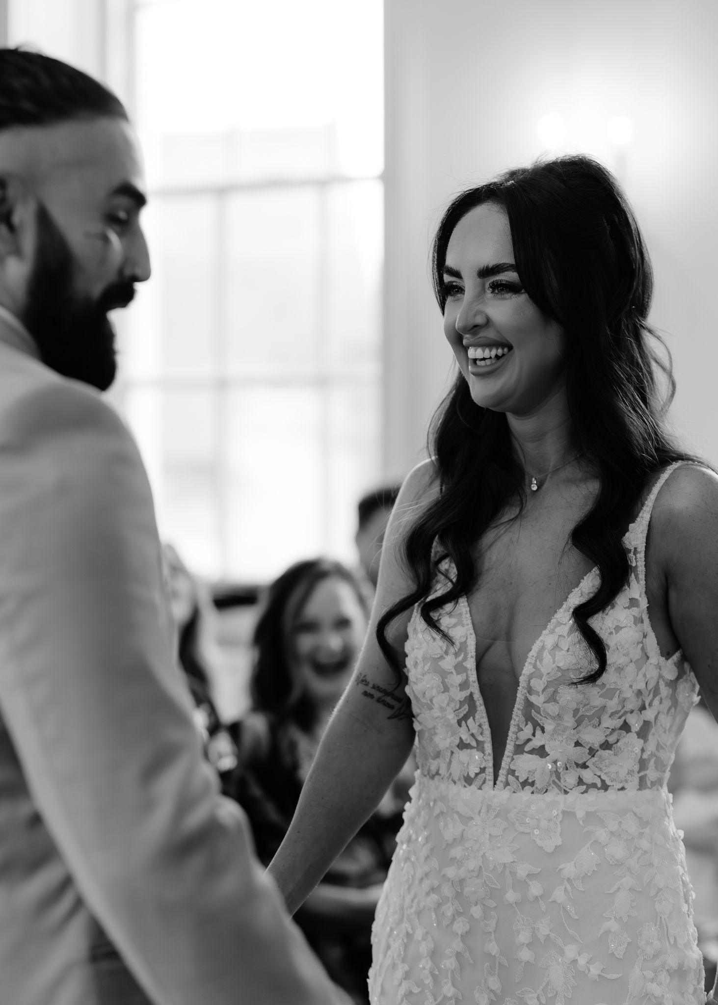 A sequence of candid black and white wedding moments showing a couple sharing joyful interactions during their celebration.