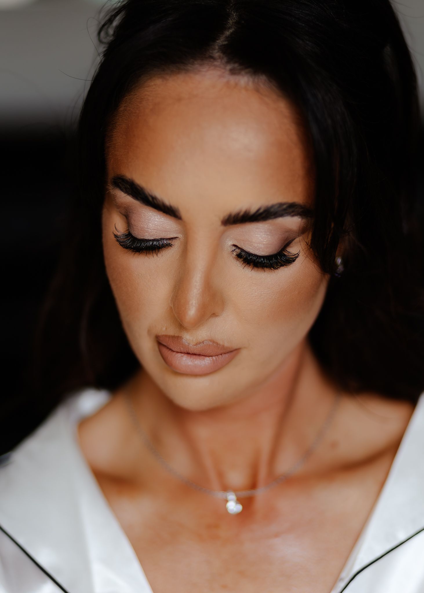 Close-up beauty shot showcasing glamorous eye makeup with long lashes and perfectly groomed eyebrows.