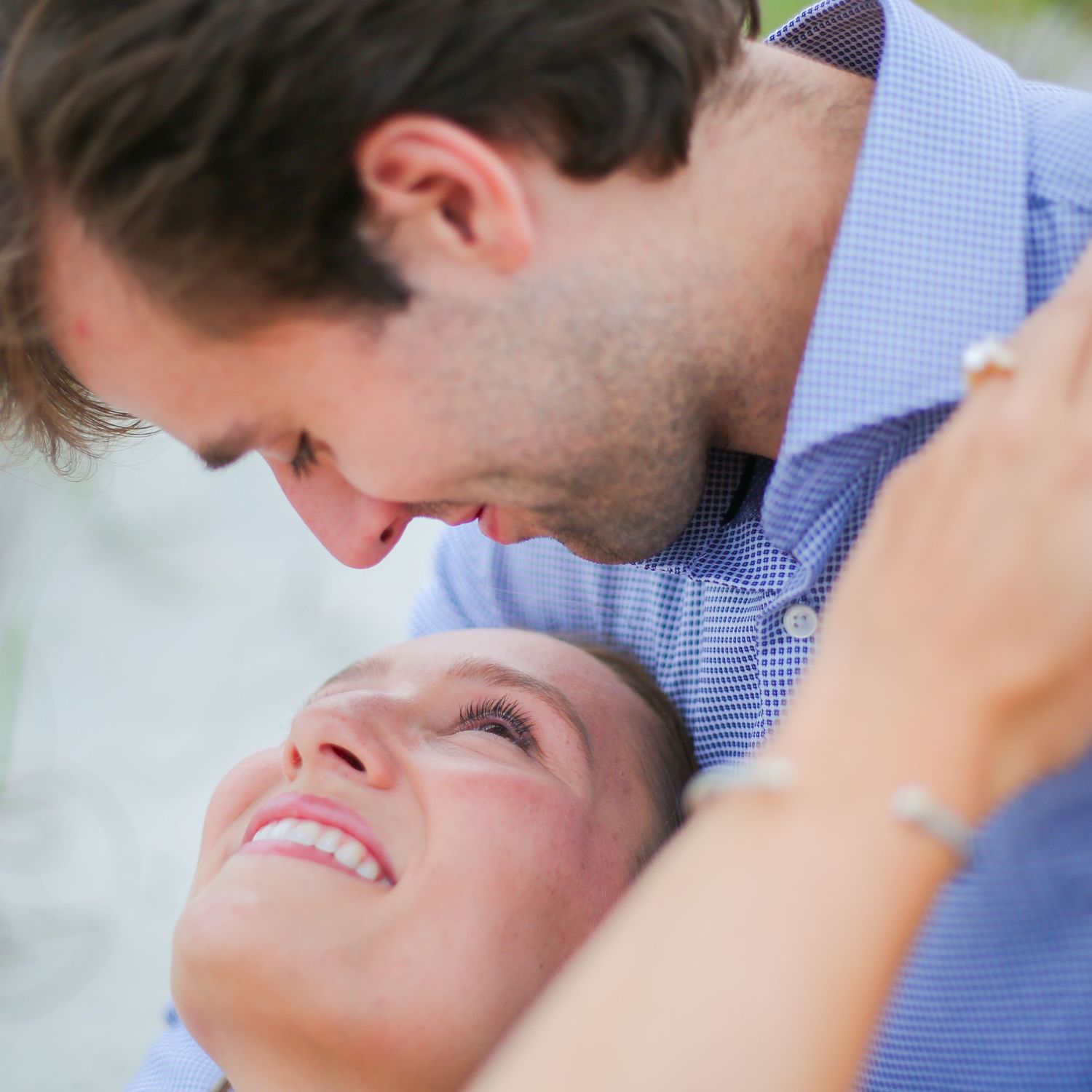 Romantic couple sharing an intimate moment outdoors in soft lighting.