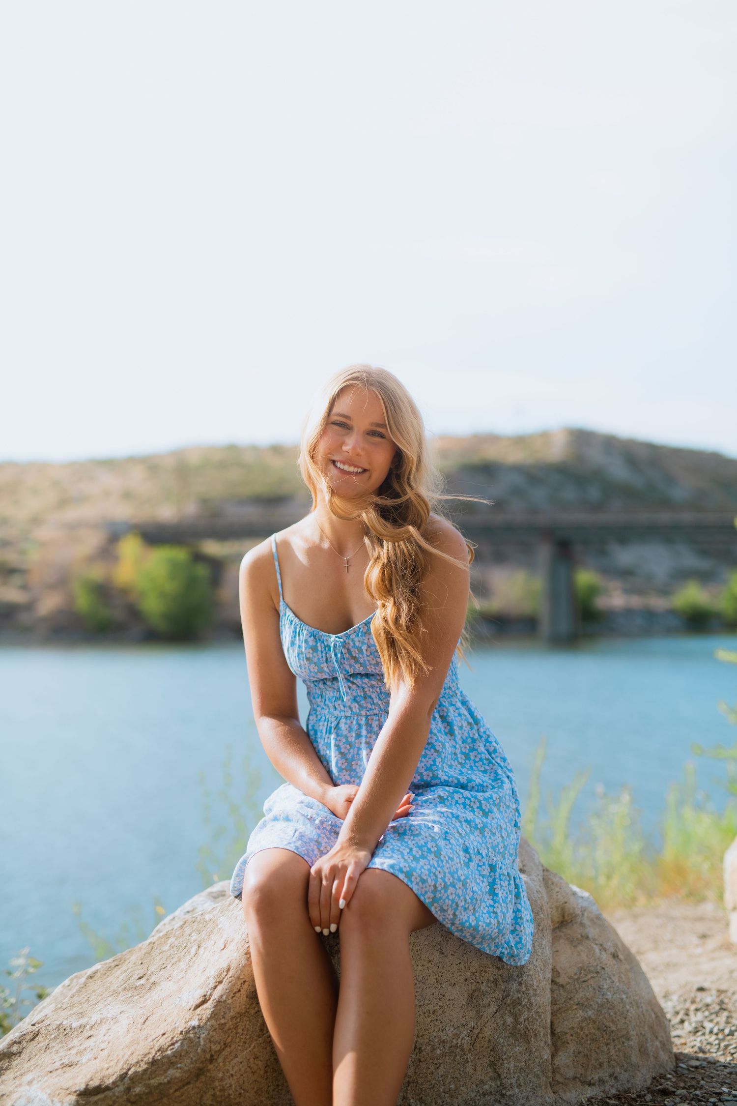 Brewster High School senior sitting near the river below the foothills in north-central Washington during an early summer day.