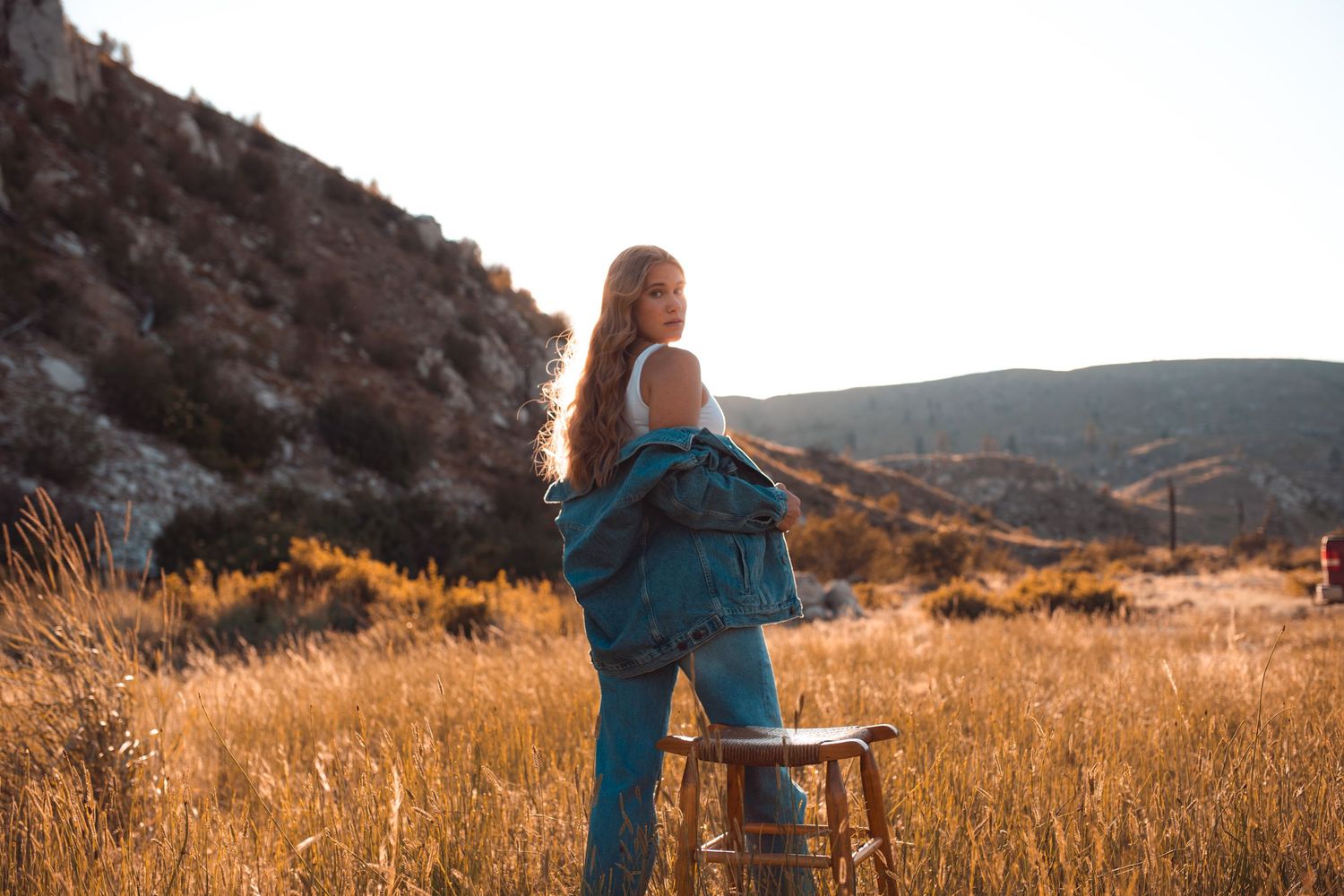 Brewster High School senior walking through the valley grasses below the foothills in north-central Washington before the start of summer.