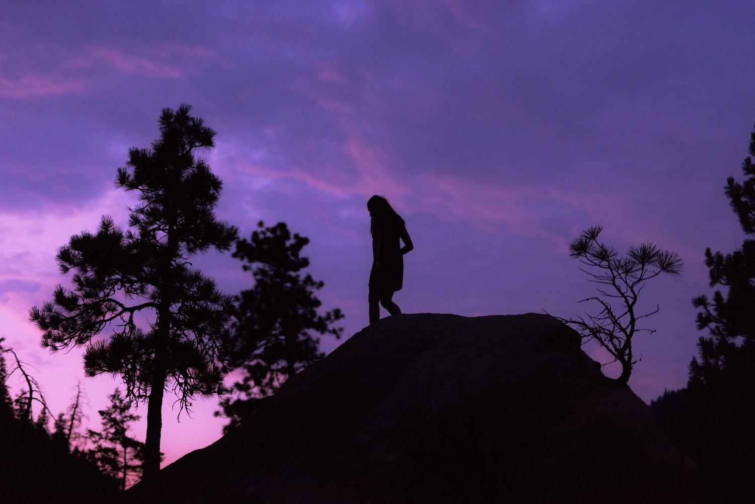 Cashmere High School senior walking atop a canyon ridge in north-central Washington at sunrise during the summer.
