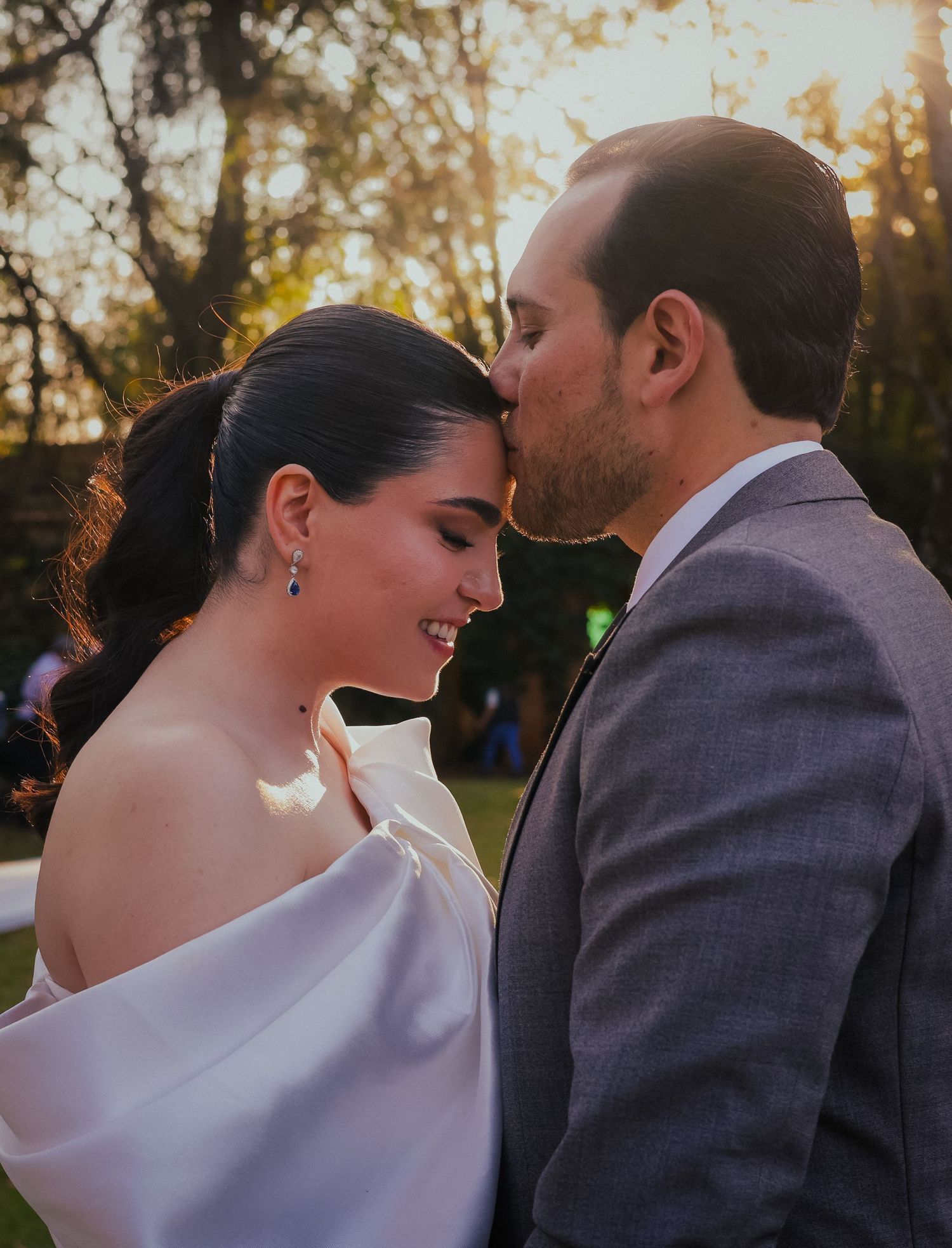 Romantic outdoor moment captured during golden hour with soft autumn lighting.