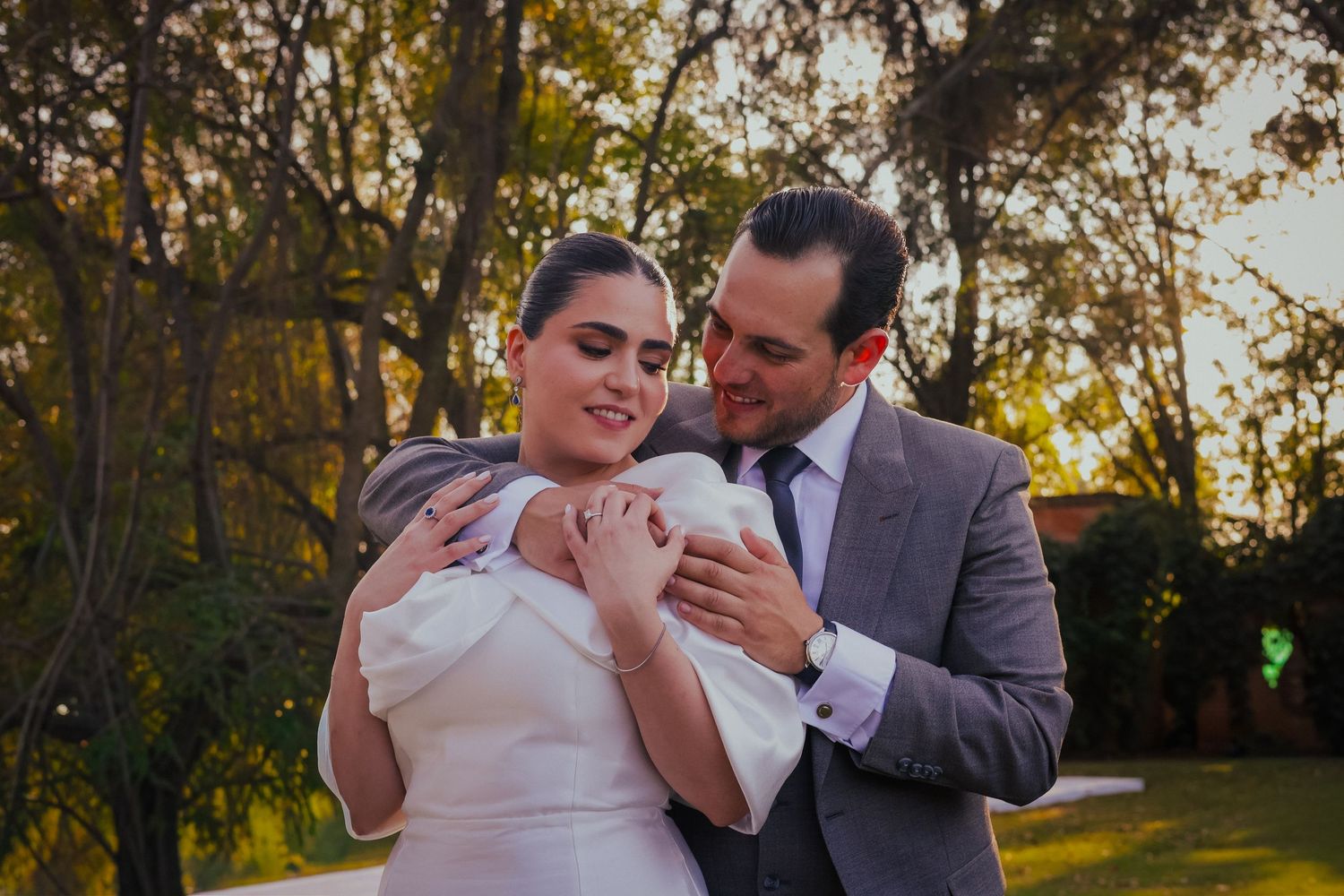 Tender moment between newlyweds in an autumn garden setting.