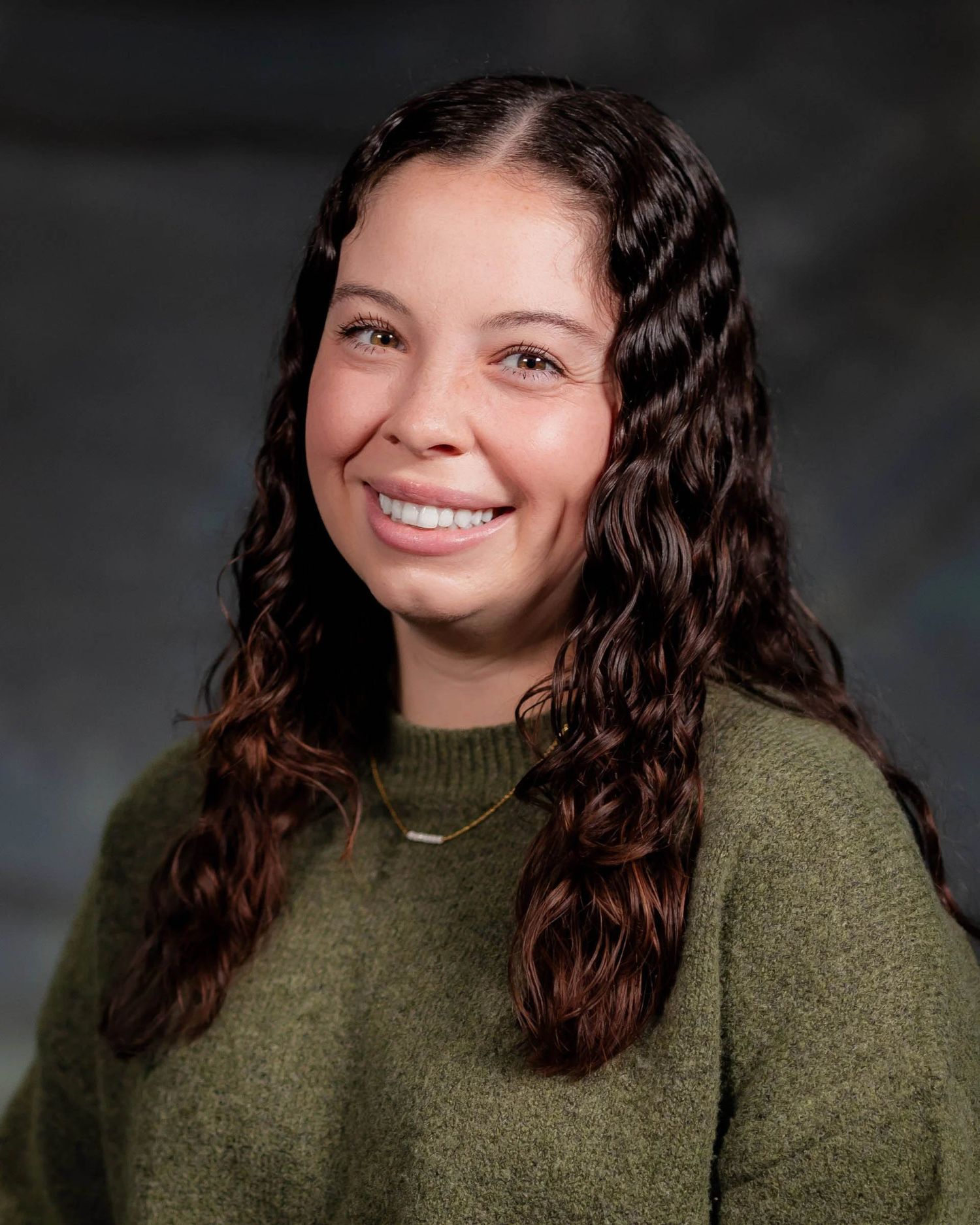 Portrait series showing expressions while wearing an olive green sweater.
