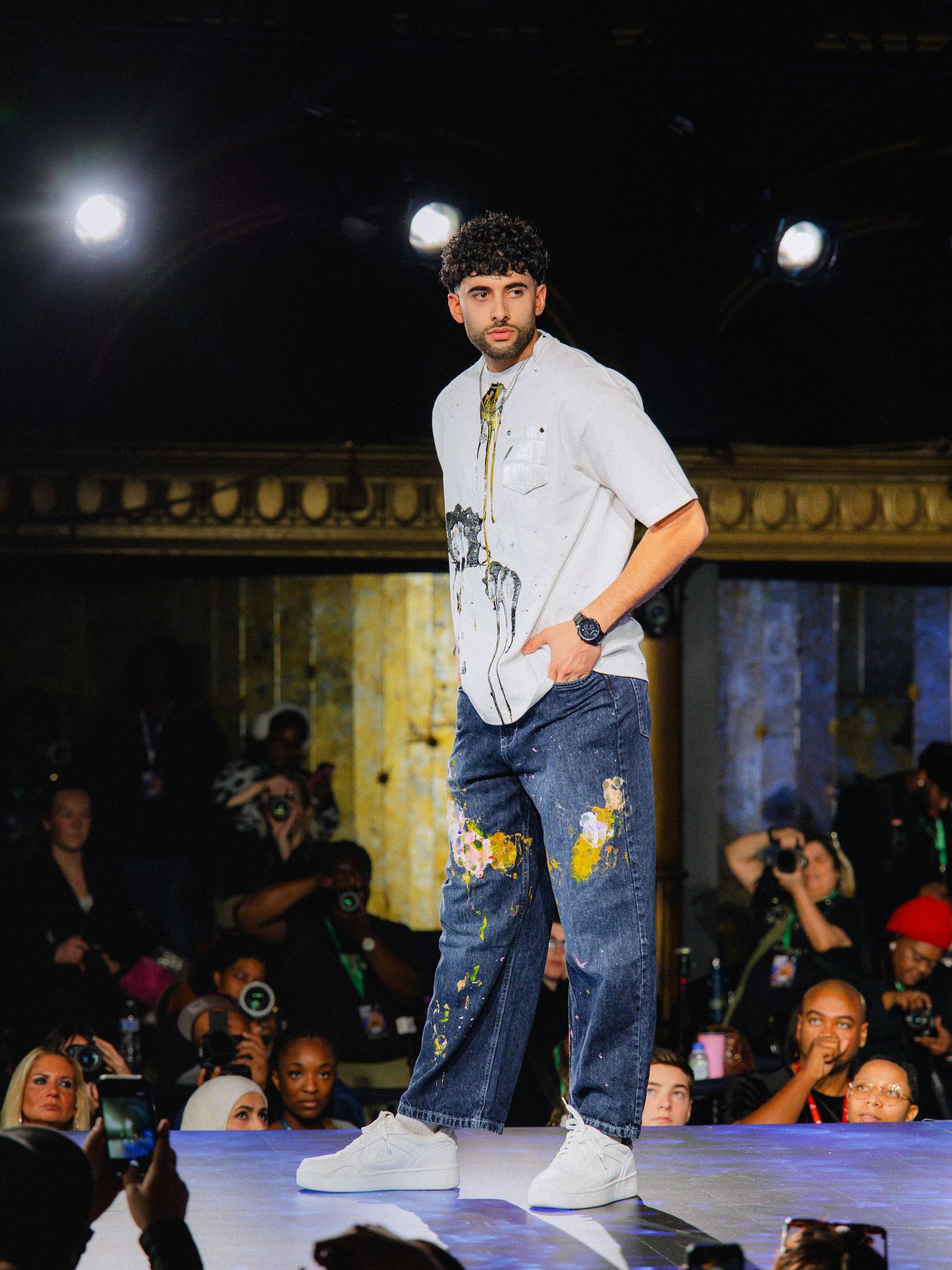 Breakdancer performs dynamic footwork moves on illuminated stage during competitive dance battle performance.