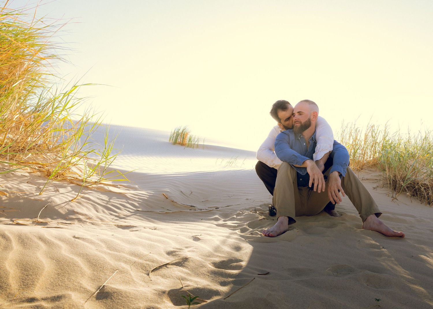 Series of romantic interactions on sandy dunes during golden hour.