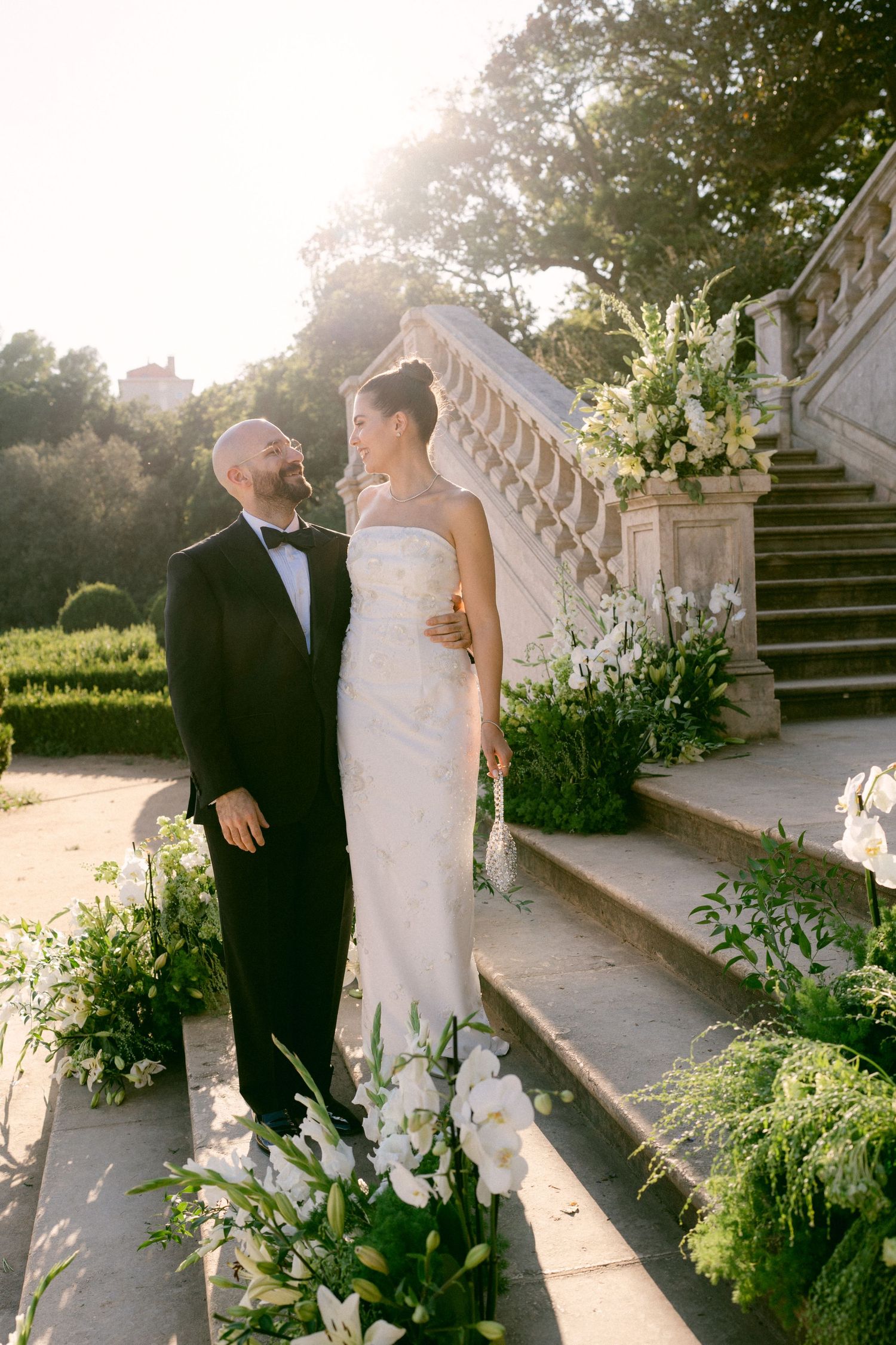 Bride and groom standing on garden stairs during wedding at Vandelli Gardens in Lisbon, Portugal