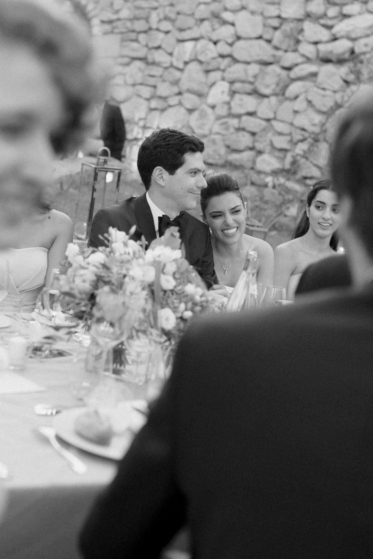 Wedding guests laughing during reception dinner at destination wedding in Cassis, France