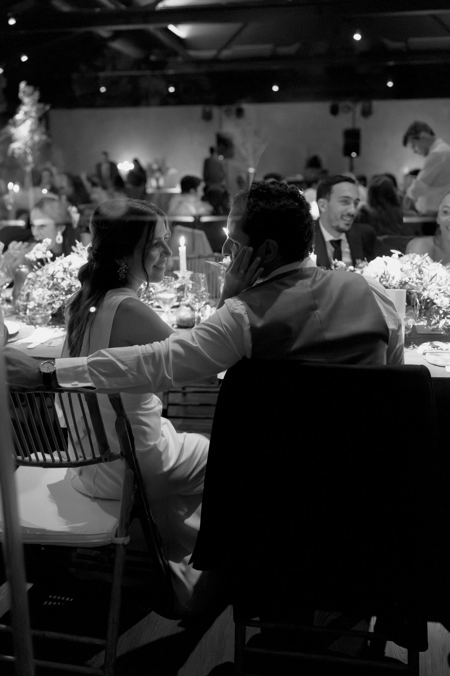 Bride and groom sharing an intimate moment during wedding reception dinner in Lisbon, Portugal