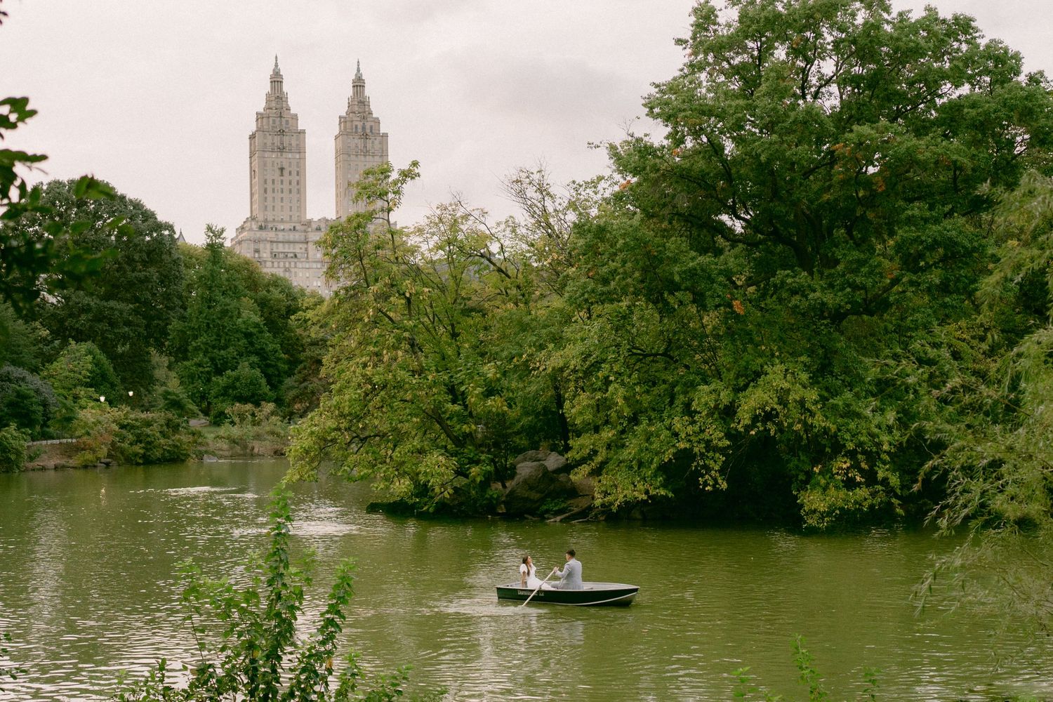 Couple rowing boat during engagement session in Central Park, New York