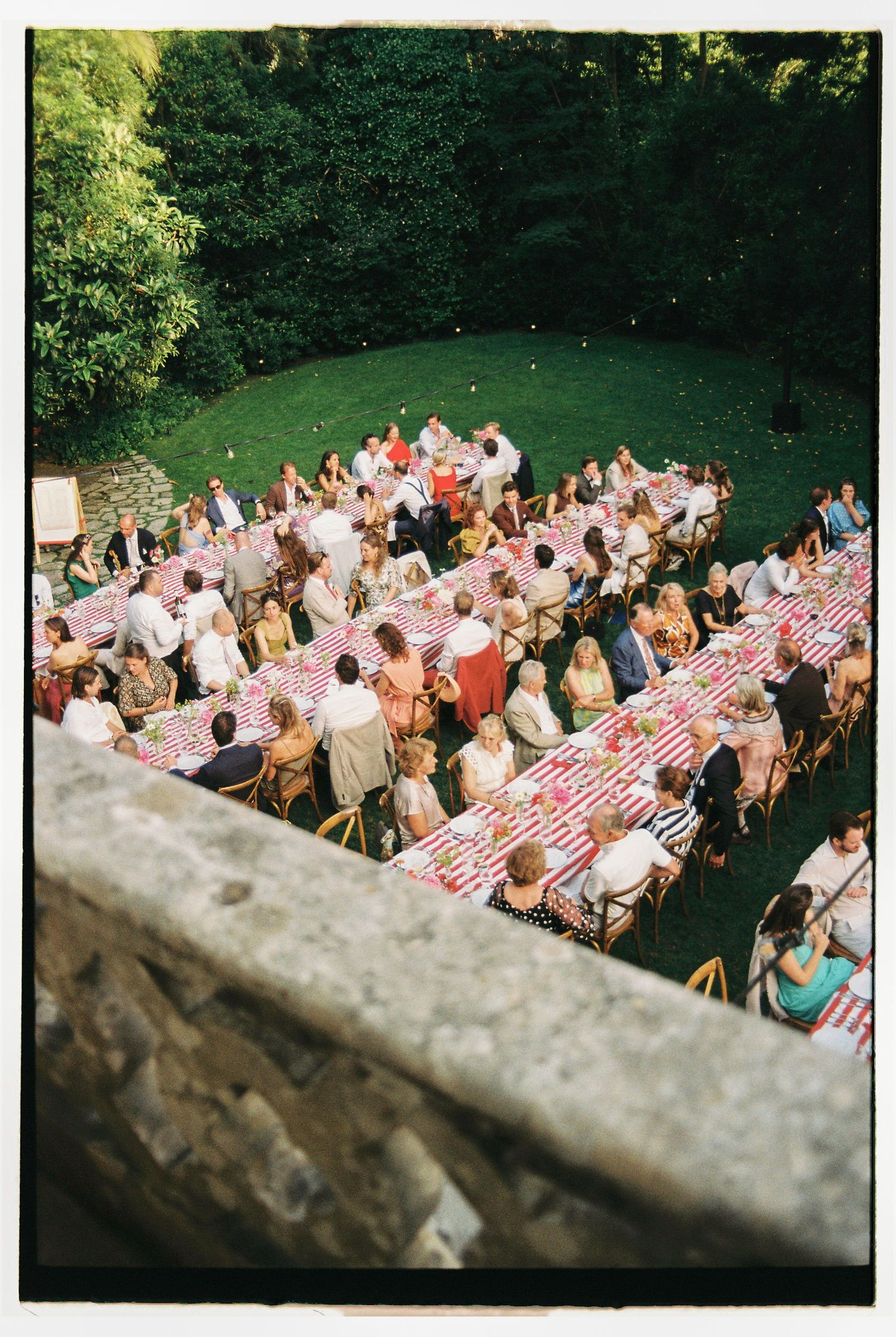 Guests seated at long tables during outdoor garden wedding reception in Sintra, Portugal