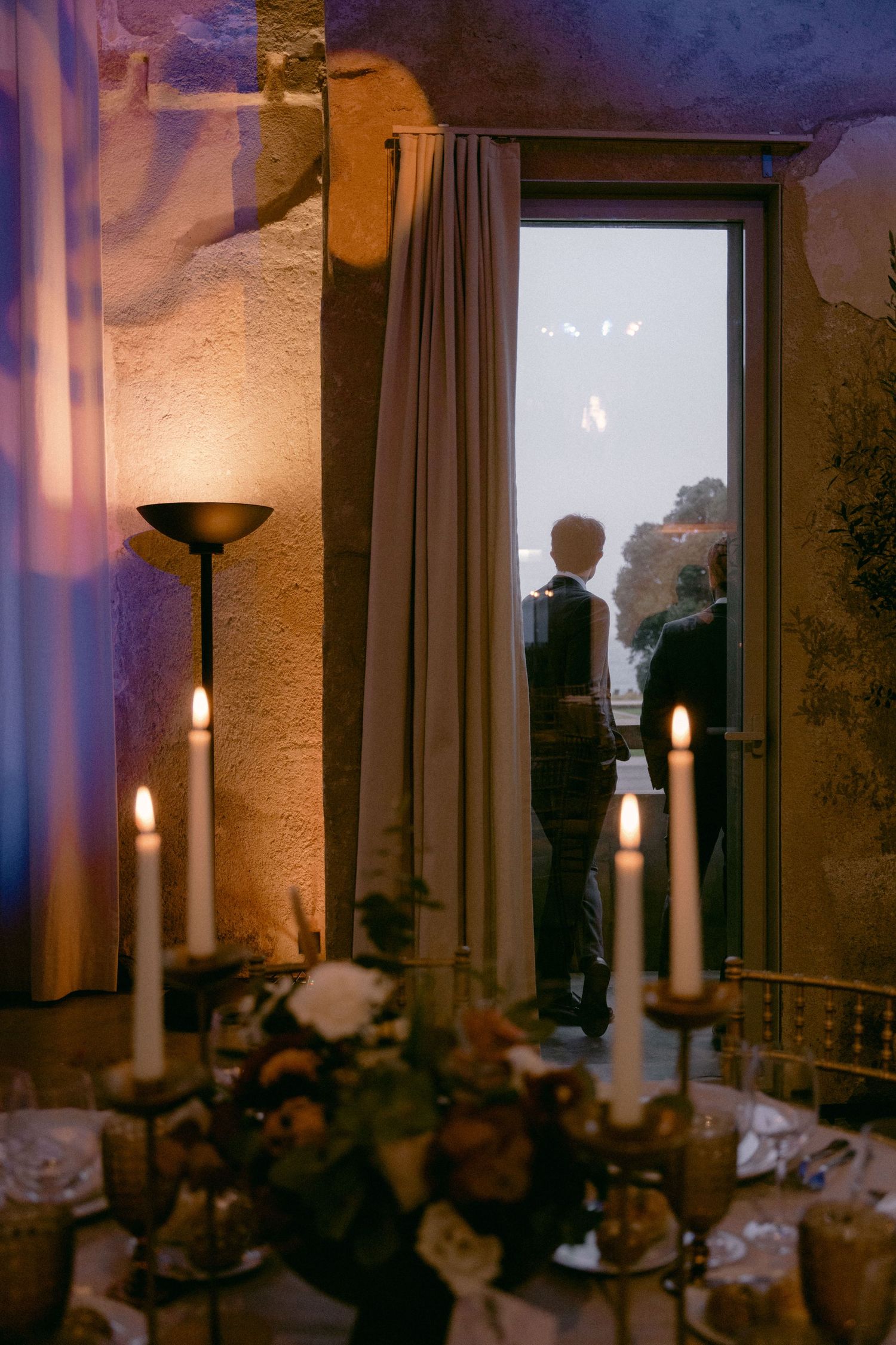 Candlelit wedding reception table during evening celebration